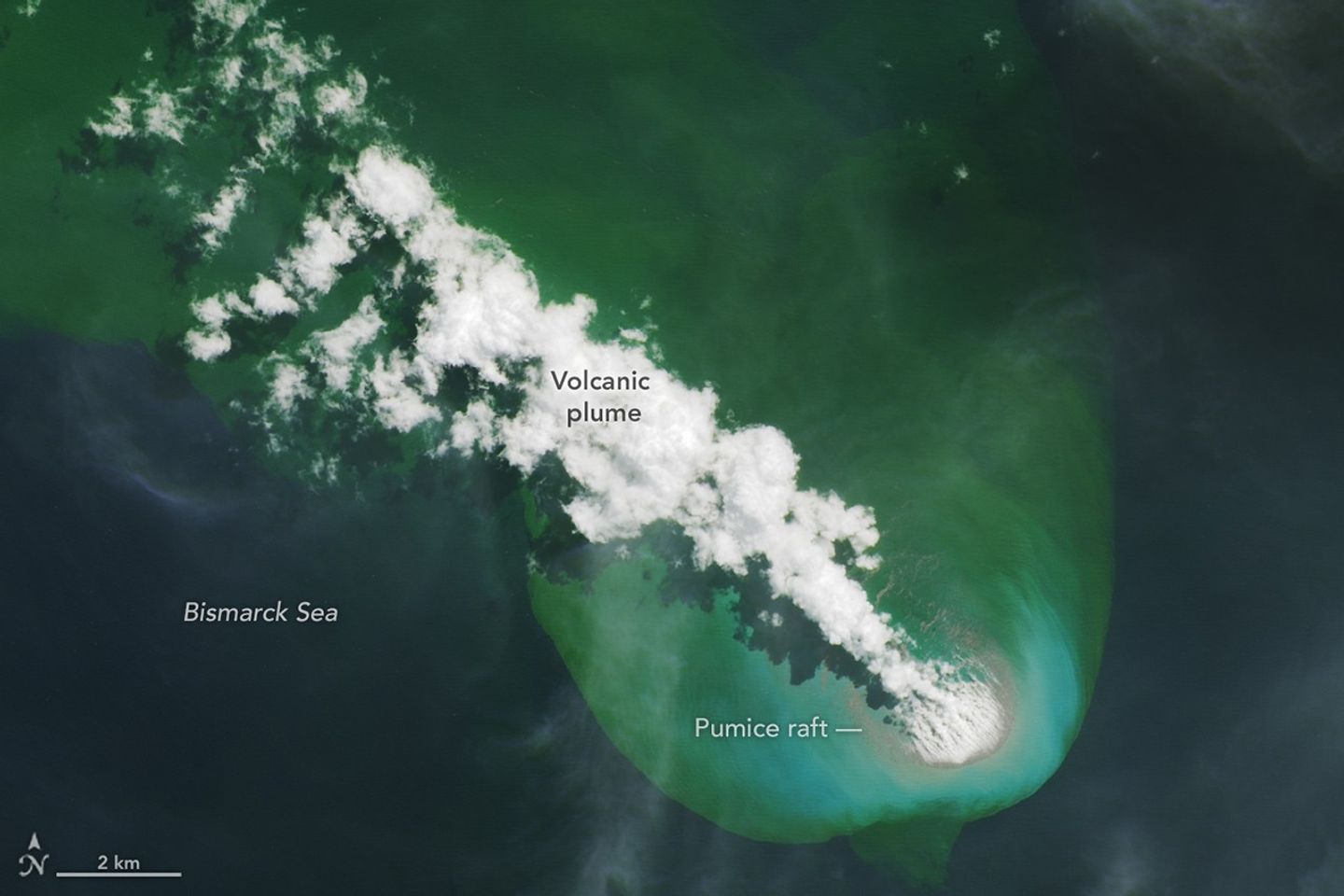 A bright-white volcanic plume and an area of greenish water extend to the northwest from an underwater eruption.