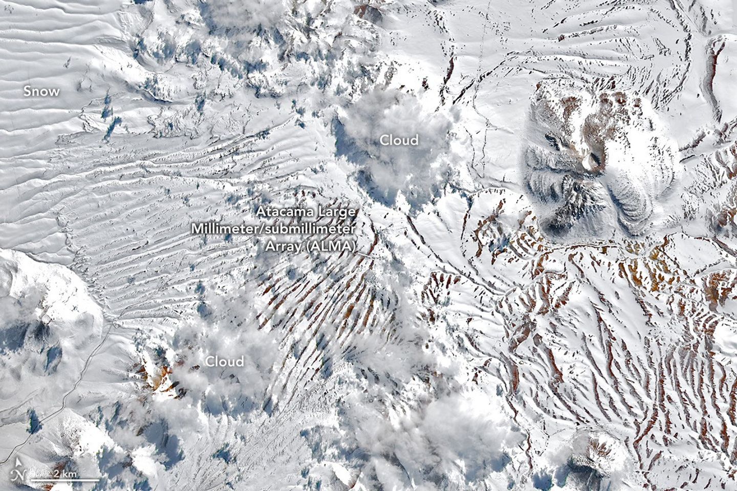 The same plateau is now blanketed in white snow. The location of the radio telescope array is nearly indistinguishable from the surrounding terrain.