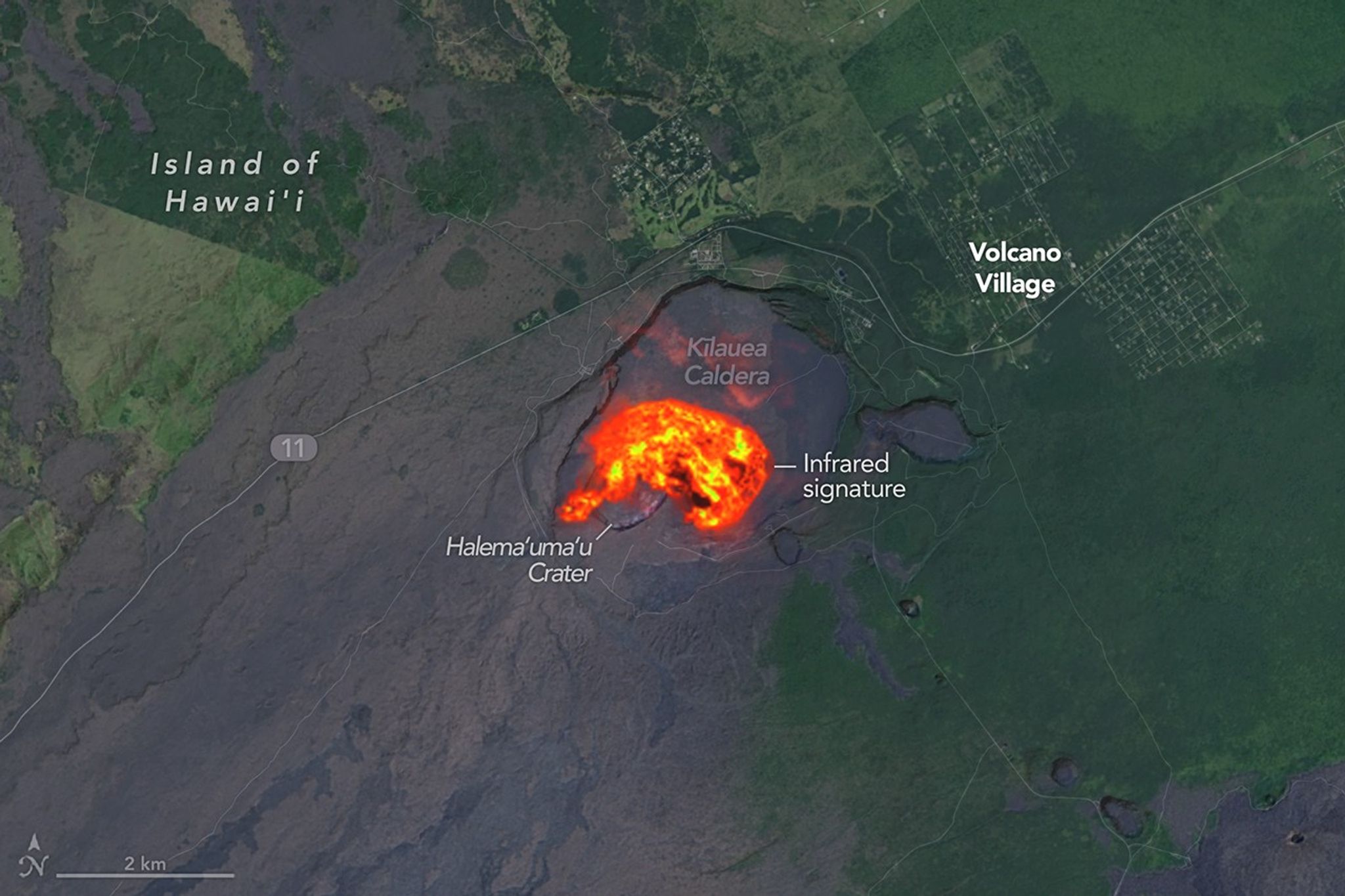 The heat signature from an eruption at Kilauea glows yellow and orange in the volcano’s summit crater.