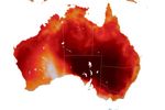 A map of Australia depicts near-surface air temperatures, where most of the country is warm, shown as orange to red. Extreme heat is concentrated over the southeast, and a small cooler blue area appears in Western Australia.