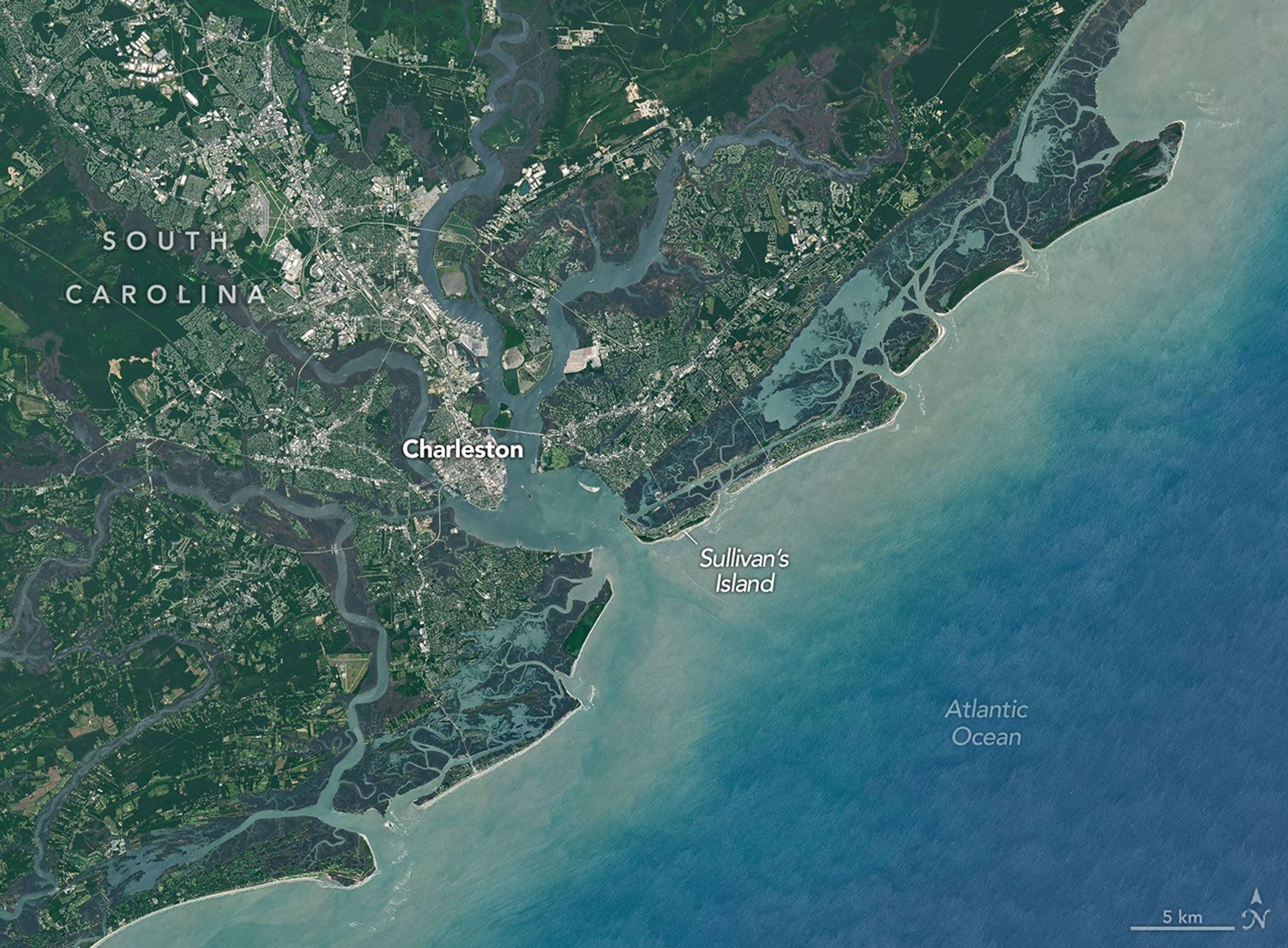 A wider version of the satellite image shows Sullivan’s Island, centered, in relation to Charleston, which lies to the northwest.