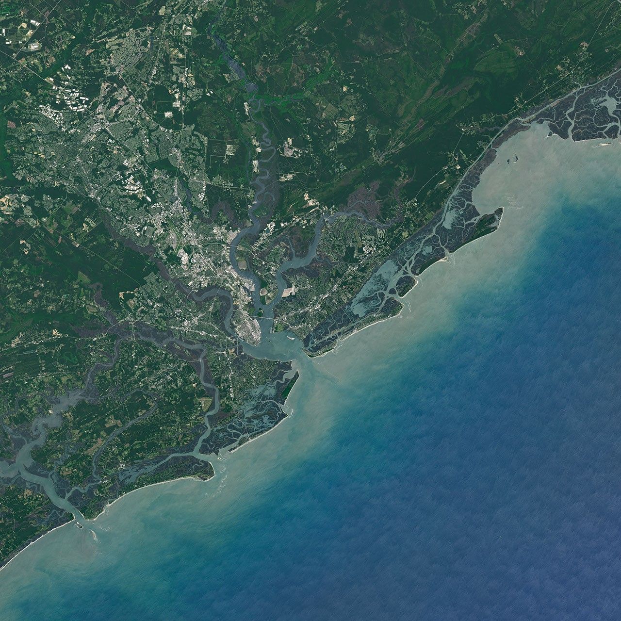 A wider version of the satellite image shows Sullivan’s Island, centered, in relation to Charleston, which lies to the northwest.