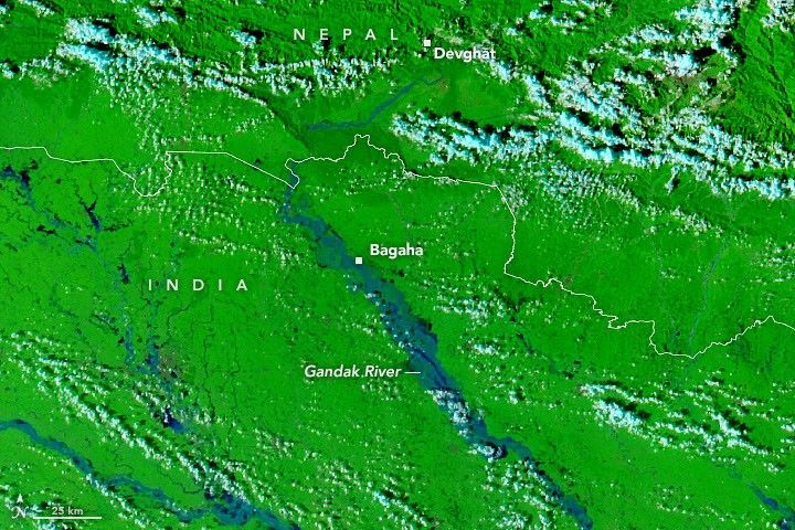 A false-color satellite image shows the same area during the flooding on September 29, 2026. The river appears much wider.