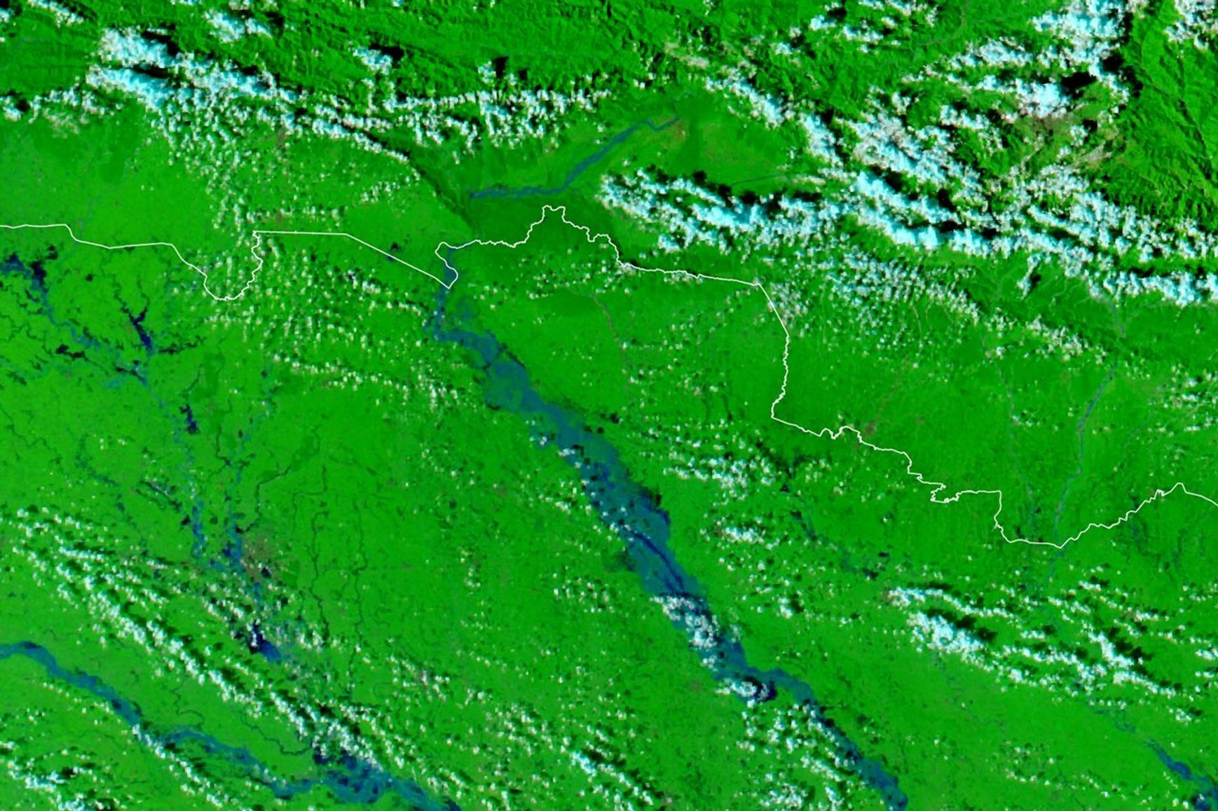 A false-color satellite image shows the same area during the flooding on September 29, 2026. The river appears much wider.