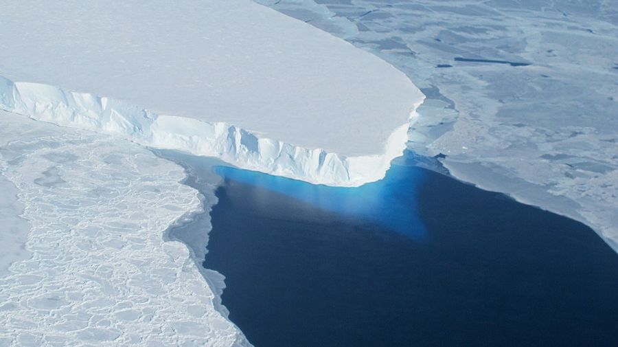 An ice glacier protrudes into water