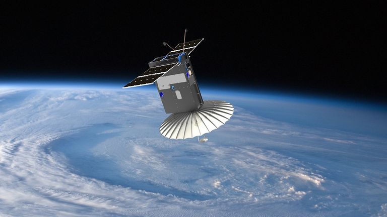 Illustration of the RainCube satellite in space above Earth. The small CubeSat features solar panels and a large, umbrella-like deployable radar antenna pointed downward toward the swirling clouds of a storm system over the planet.