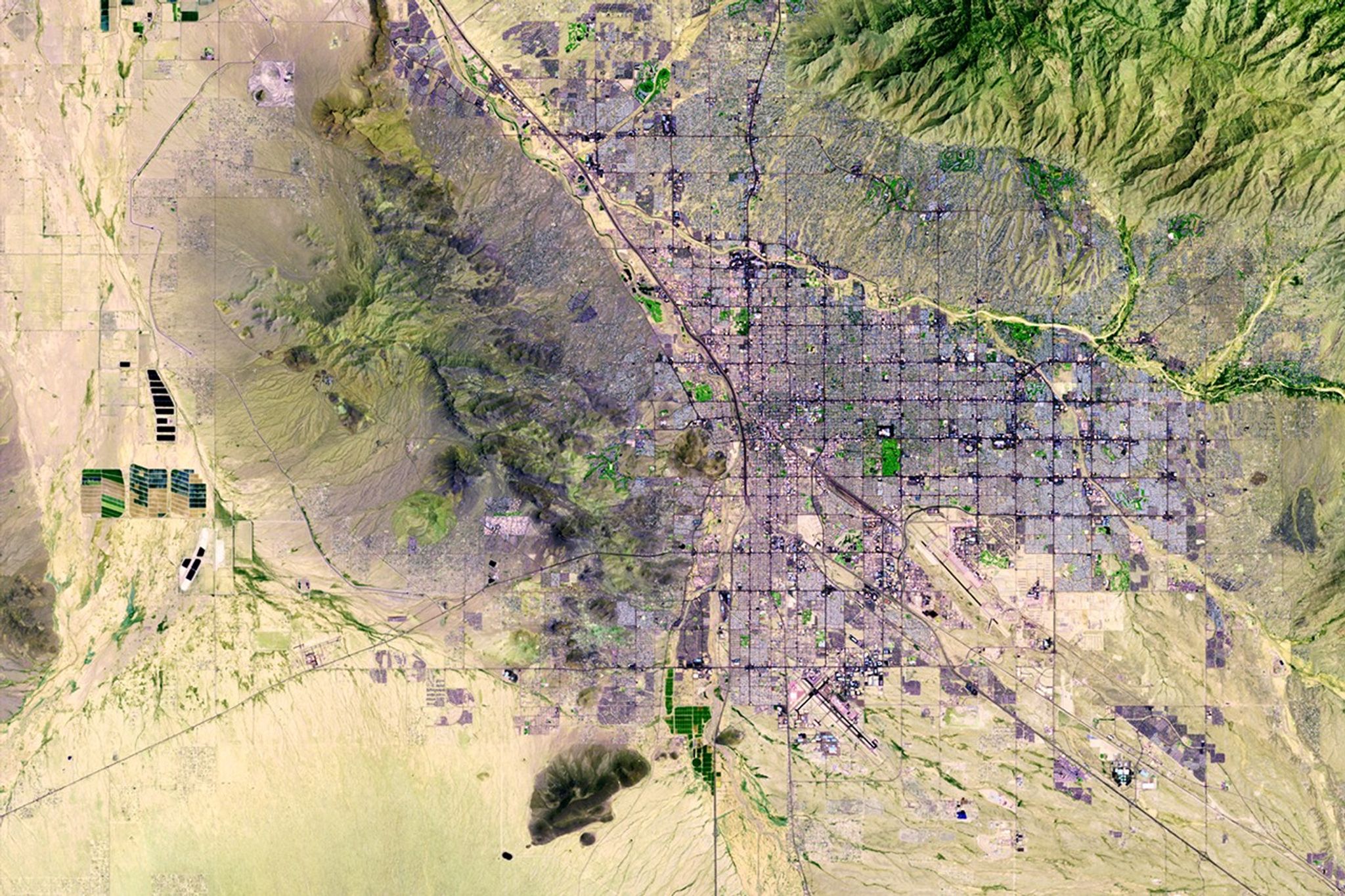 Tucson in the Sonoran Desert in southern Arizona. It is one of the oldest continually inhabited areas of North America, with evidence of settlements 3,000 years ago. The city has grown quickly over the past 30 years, due in part to the rapid growth of technology firms. Population in the greater Tucson area has increased from about 600,000 in 1980 to more than one million in 2011. Expansion has been largely in the eastern region since mountains on the north, west and south restrict development. As with many western cities, Tucson was organized on a grid pattern, which can be seen from space.   Images taken by the Thematic Mapper sensor onboard Landsat 5. Source: USGS Landsat Missions Gallery, "Tuscon, Arizona," U.S. Department of the Interior / U.S. Geological Survey.