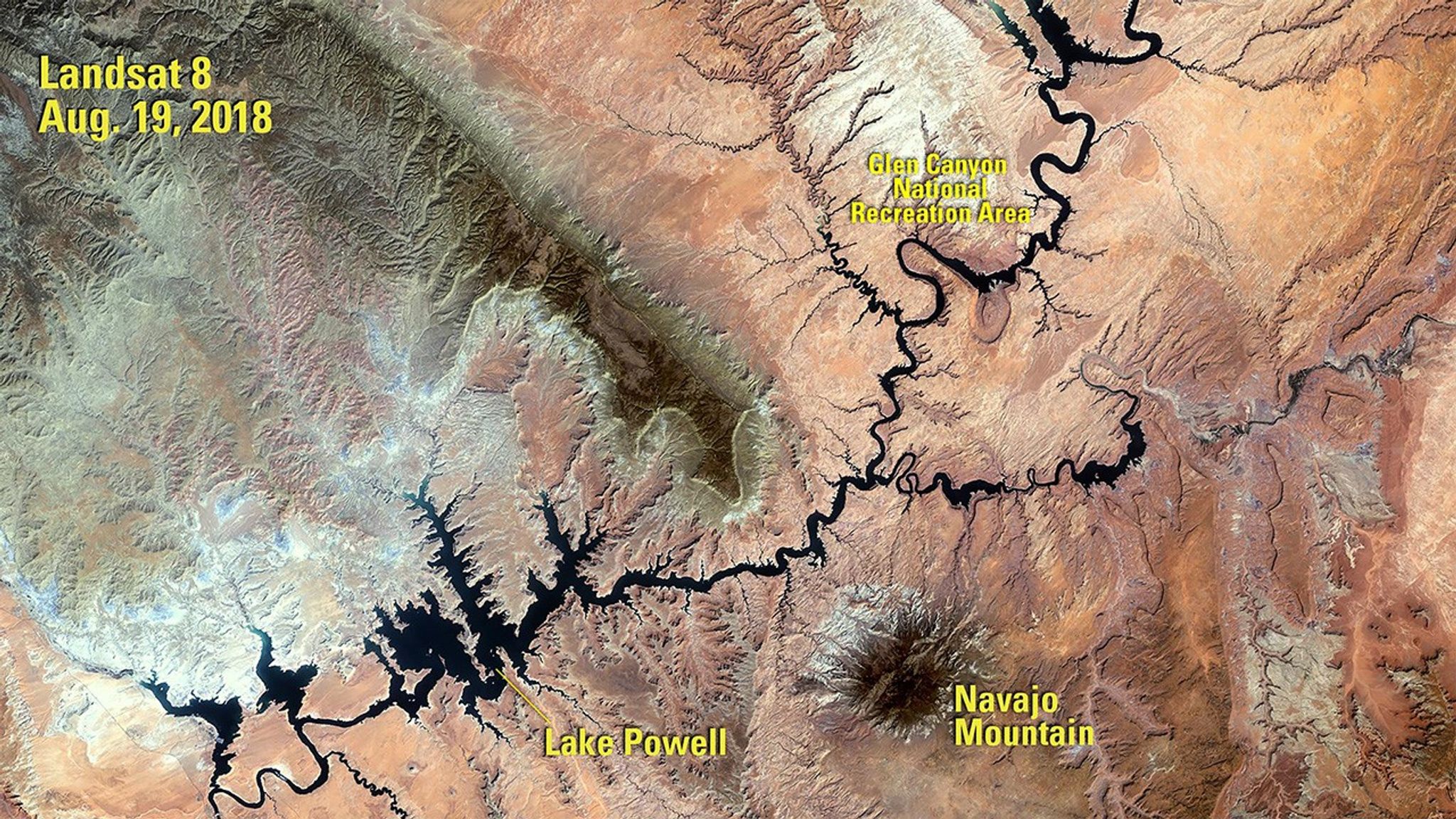 The 1984 image shows Lake Powell a year after its highest water level was recorded. The 2018 image was taken following a period of drought that began in 2000. When the water volume was measured five months later, it was less than half of what the lake can hold. Powell is a reservoir, formed in 1963 when the Glen Canyon Dam was built on the Colorado River. It resides mostly in Utah, with its southern end at the dam in northern Arizona. See also Drought in Lake Powell, Arizona and Utah.   The 1984 image was taken by Landsat 5. The 2018 image was taken by Landsat 8. Source: U.S. Geological Survey’s National Land Imaging Image Collections