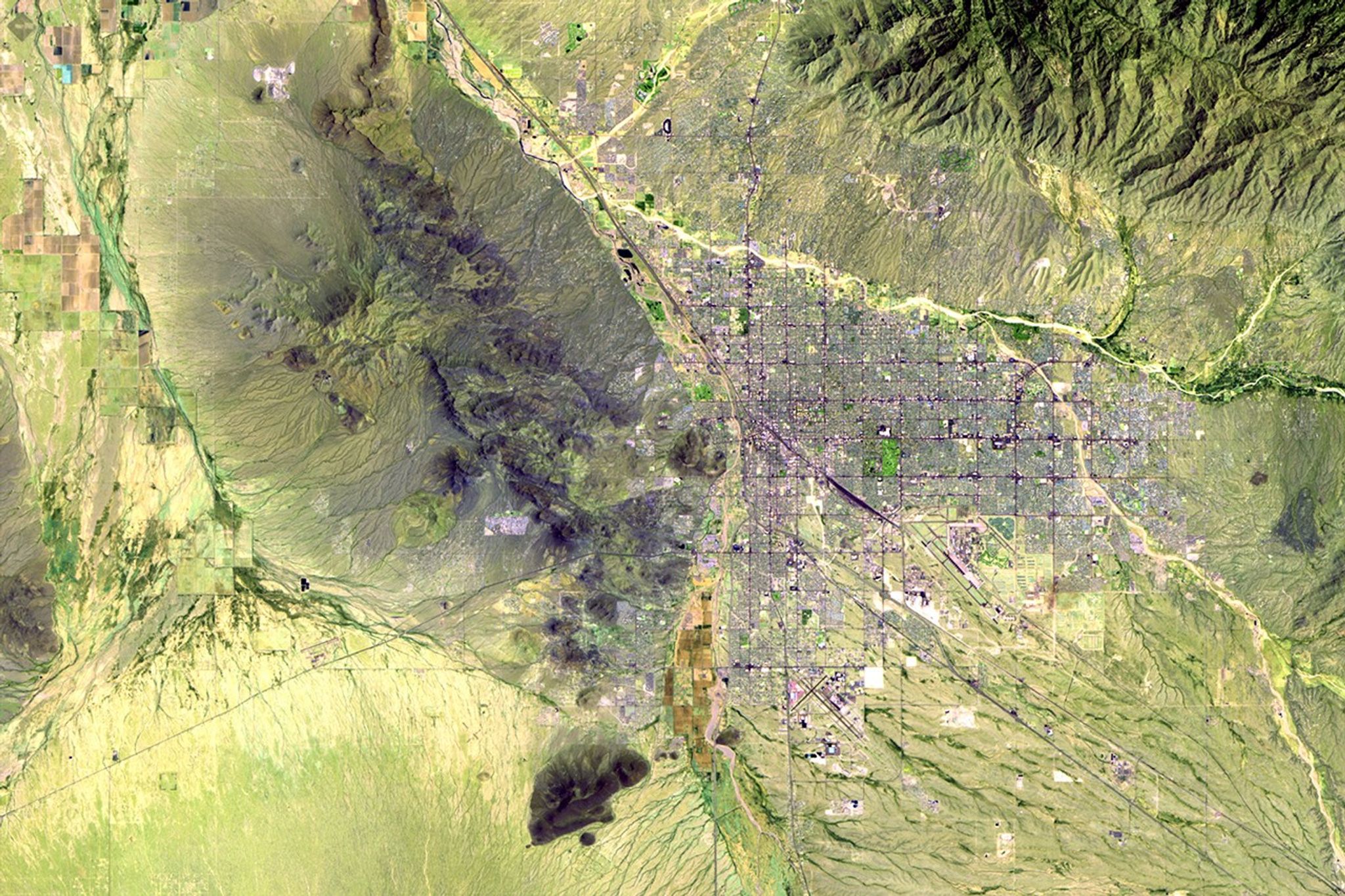 Tucson in the Sonoran Desert in southern Arizona. It is one of the oldest continually inhabited areas of North America, with evidence of settlements 3,000 years ago. The city has grown quickly over the past 30 years, due in part to the rapid growth of technology firms. Population in the greater Tucson area has increased from about 600,000 in 1980 to more than one million in 2011. Expansion has been largely in the eastern region since mountains on the north, west and south restrict development. As with many western cities, Tucson was organized on a grid pattern, which can be seen from space.   Images taken by the Thematic Mapper sensor onboard Landsat 5. Source: USGS Landsat Missions Gallery, "Tuscon, Arizona," U.S. Department of the Interior / U.S. Geological Survey.