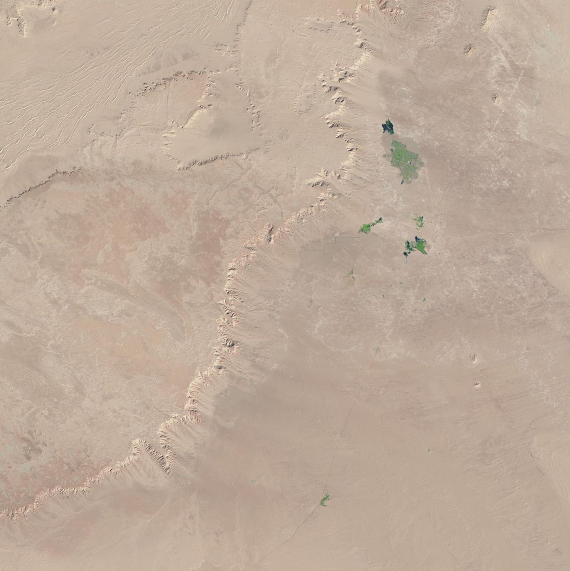 Unlike much newly developed desert agriculture, the western Egyptian fields seen here are watered not by deep-well irrigation, but rather with surface water associated with the Al Farafra Oasis. These images show the increased agricultural activity near the town of Qasr al Farafra. Increased accessibility from improved infrastructure, including paved roads to the town, brings both agricultural laborers and tourists. Images taken by the Thematic Mapper sensor onboard Landsat 5 and the Enhanced Thematic Mapper Plus onboard Landsat 7. Source: U.S. Geological Survey (USGS) Landsat Missions Gallery, "Al Farafra Oasis," U.S. Department of the Interior / USGS and NASA.