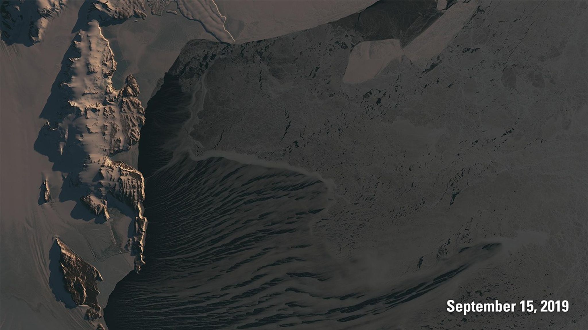 These images contrast the sunlight Antarctica receives near spring equinox (September image) and summer solstice (December image). The low sun angles near equinox create longer shadows that reveal the ruggedness of the mountains. The higher angles near solstice shorten the shadows and brighten the landscape, while the marked reduction in sea ice exposes more of the darker ocean.   Images taken by Landsat 8. Source: U.S. Geological Survey’s National Land Imaging Image Collections