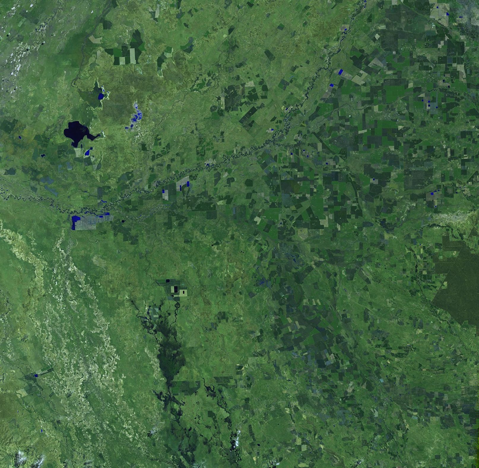 The worst flooding in decades affected an area in southern Australia the size of Germany and France combined, causing at least 10 deaths. It cut off 22 towns, affected over 200,000 people, closed 75 percent of the area's coalmines, devastated the country's wheat crop, and severely damaged housing and transport networks. The October image shows conditions before the flooding. Green tones represent vegetation, much of it wheat crops. Blue and black tones show lakes and meandering rivers. In the December picture, taken during the flood, the lakes and rivers have expanded and lowlands and agricultural fields have become saturated, as shown by the darker colors. Images taken by the Enhanced Thematic Mapper Plus sensor onboard Landsat 7. Source: U.S. Geological Survey (USGS) Landsat Missions Gallery, "Flooding in southern Australia," U.S. Department of the Interior / USGS.