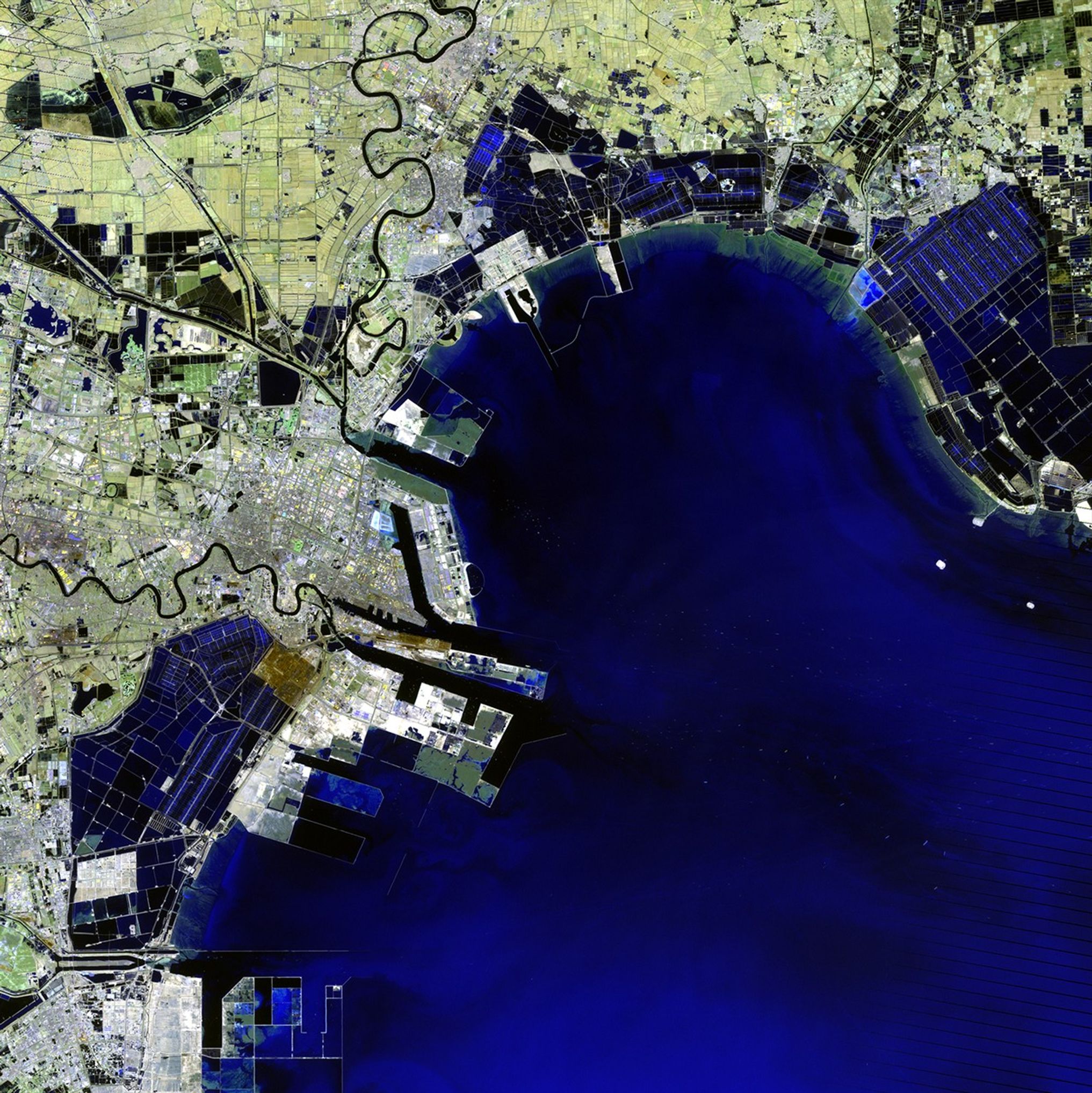 The Binhai New Area — once home to salt farms, reed marshes and wasteland — has grown into one of China's key economic hubs. Since development began in the 1990s, it has become the home of numerous aerospace, oil, chemical and other manufacturing industries. Plans for coming years include an international airport. The changes over 20 years can be seen in these images acquired in 1992 and 2012. The Binhai New Area is located on the coast of the Bohai Sea Region southeast of China's capital city, Beijing. 1992 image taken by the Thematic Mapper sensor onboard Landsat 5. 2012 image taken by the Enhanced Thematic Mapper Plus sensor onboard Landsat 7. Source: U.S. Geological Survey (USGS) Landsat Missions Gallery, "Binhai New Area, China," U.S. Department of the Interior / USGS.