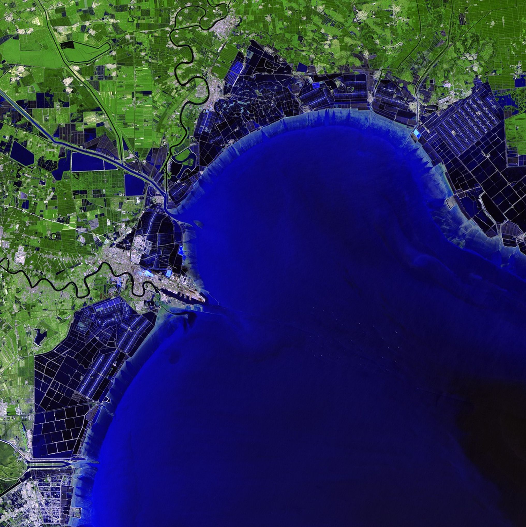 The Binhai New Area — once home to salt farms, reed marshes and wasteland — has grown into one of China's key economic hubs. Since development began in the 1990s, it has become the home of numerous aerospace, oil, chemical and other manufacturing industries. Plans for coming years include an international airport. The changes over 20 years can be seen in these images acquired in 1992 and 2012. The Binhai New Area is located on the coast of the Bohai Sea Region southeast of China's capital city, Beijing. 1992 image taken by the Thematic Mapper sensor onboard Landsat 5. 2012 image taken by the Enhanced Thematic Mapper Plus sensor onboard Landsat 7. Source: U.S. Geological Survey (USGS) Landsat Missions Gallery, "Binhai New Area, China," U.S. Department of the Interior / USGS.