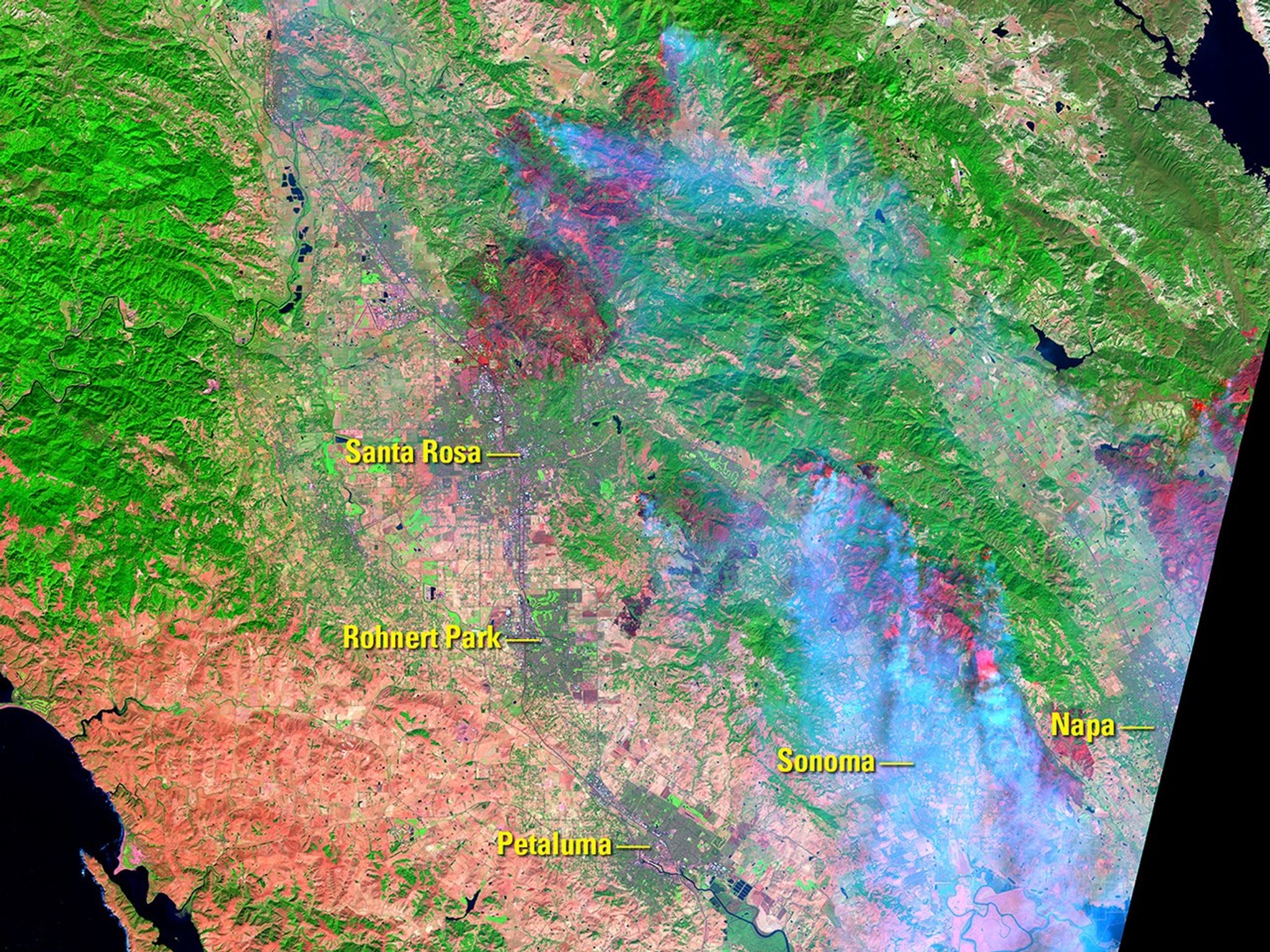 Wildfires fanned by wind gusts of 50 mph (80 kph) broke out on Oct. 8, 2017, burning more than 100,000 acres of California wine country by the time of the Oct. 11 image. A wet winter had encouraged the growth of vegetation, which dried out during a hot, dry summer and became fuel for the fires. Burned areas appear maroon and smoke appears light blue in the Oct. 11 image. The colors are false because the images were made from infrared data.   Images taken by Landsat 8. Source: USGS Land Remote Sensing Image Collections.