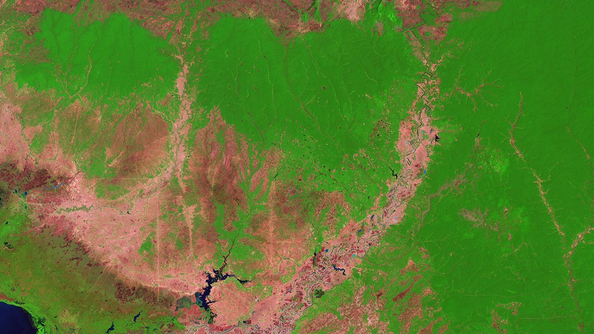 According to University of Maryland researchers who used Landsat satellite data, Cambodia had the world’s most accelerated rate of deforestation between 2001 and 2014, losing 5,560 square miles (about 14,400 square kilometers) of forests during that time. The researchers attributed this rate in part to changes in global rubber prices and a surge in land-concession deals. In these images, dark green shows forests and pinkish-tan shows old, small-plot agricultural areas. In the lower left corner of the 2017 image (right), bright green landscapes peppered with darker blocks are crops, and bright green rectangles at the top left are agroforestry areas where rubber or oil palm plantations have emerged. Left image taken by the Landsat 5 satellite. Right image by Landsat 8. Source: U.S. Geological Survey (USGS) Landsat Missions Gallery: “Cambodia Experiences Rapid Rate of Forest Loss”; U.S. Department of the Interior / USGS and NASA.