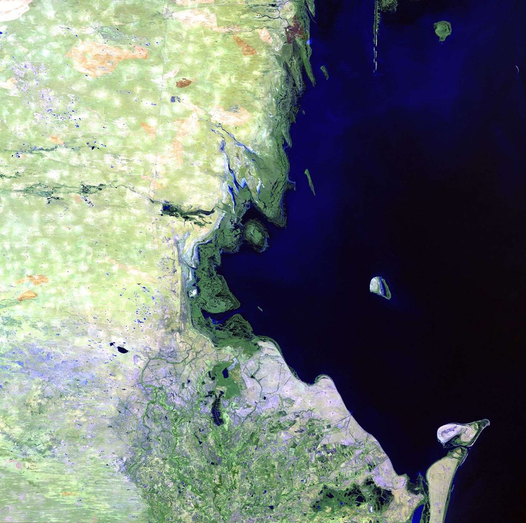 The Caspian Sea is the world's largest landlocked body of water, and it's getting bigger. In the past couple of decades, heavy rains in the greater Volga Basin have greatly increased the incoming flow from the Volga River, the Caspian's primary source of water. These images show a small portion of the shoreline. In the 2011 image, coastal settlements have been flooded, displacing inhabitants and shutting down industrial facilities. The groundwater level has also risen, leading to swamping and increasing the salinity of lowland territories. Tyuleniy Island (the prominent island) has visibly lost land mass, with the rising water contributing to the decline of the island and the marshes around it that support fowl and other animals. Images taken by the Thematic Mapper sensor onboard Landsat 5. Source: USGS Landsat Missions Gallery, "Rising Water Changes Caspian Shoreline," U.S. Department of the Interior / U.S. Geological Survey.