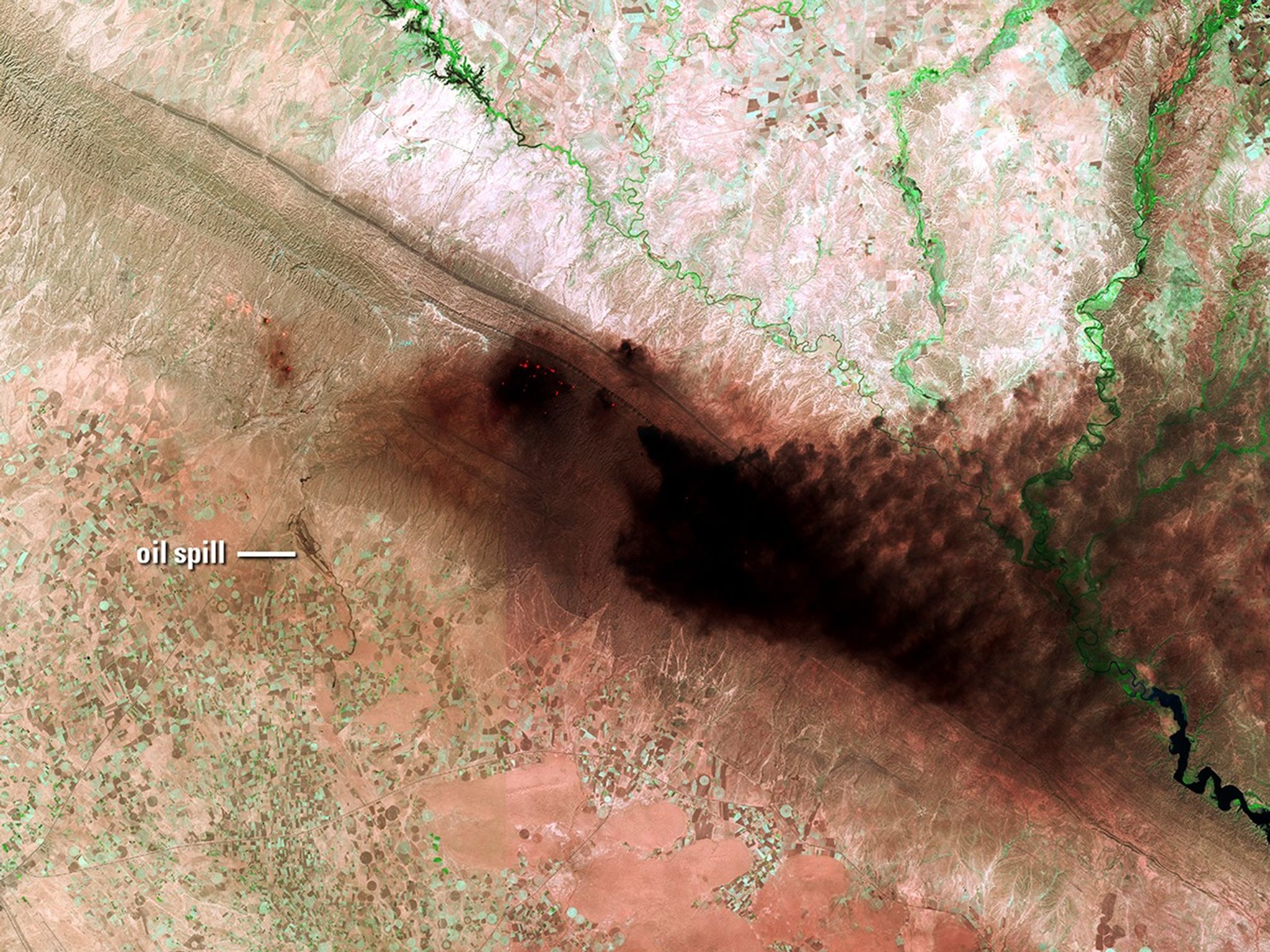 These images show the Hamrin Mountains in northern Iraq before and during an oil well fire. To the left of the thick, dark smoke in the 2017 image, an oil spill is visible flowing over valley agricultural land for about 7 miles (11 kilometers).   2014 image taken by Landsat 8; 2017 image taken by Sentinel-2A. Source: USGS Land Remote Sensing Image Collections.