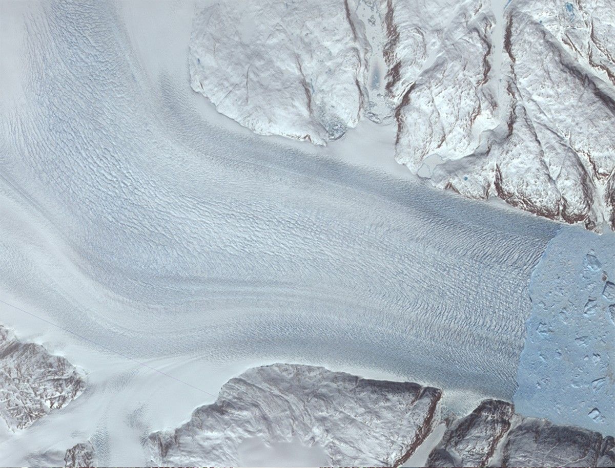 Along the margin of the Greenland Ice Sheet, outlet glaciers flow as icy rivers through fjords and out to sea. These pictures show a fjord in which Helheim Glacier (on the left) is crumbling into large and small icebergs (light blue, on the right). The glacier outlet ("calving front") held steady from the 1970s until about 2001, then began to retreat towards its source about 7.5 kilometers (4.7 miles) between 2001 and 2005. The glacier's flow to the sea has also sped up. NASA images created by Jesse Allen, NASA Earth Observatory, using data from the Advanced Spaceborne Thermal Emission and Reflection Radiometer (ASTER) on NASA's Terra satellite. Courtesy of NASA/GSFC/METI/ERSDAC/JAROS, and the U.S./Japan ASTER Science Team.