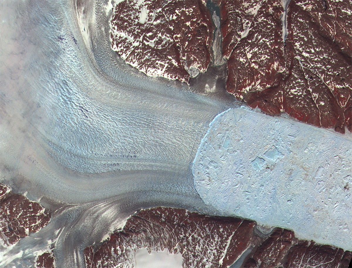 Along the margin of the Greenland Ice Sheet, outlet glaciers flow as icy rivers through fjords and out to sea. These pictures show a fjord in which Helheim Glacier (on the left) is crumbling into large and small icebergs (light blue, on the right). The glacier outlet ("calving front") held steady from the 1970s until about 2001, then began to retreat towards its source about 7.5 kilometers (4.7 miles) between 2001 and 2005. The glacier's flow to the sea has also sped up. NASA images created by Jesse Allen, NASA Earth Observatory, using data from the Advanced Spaceborne Thermal Emission and Reflection Radiometer (ASTER) on NASA's Terra satellite. Courtesy of NASA/GSFC/METI/ERSDAC/JAROS, and the U.S./Japan ASTER Science Team.