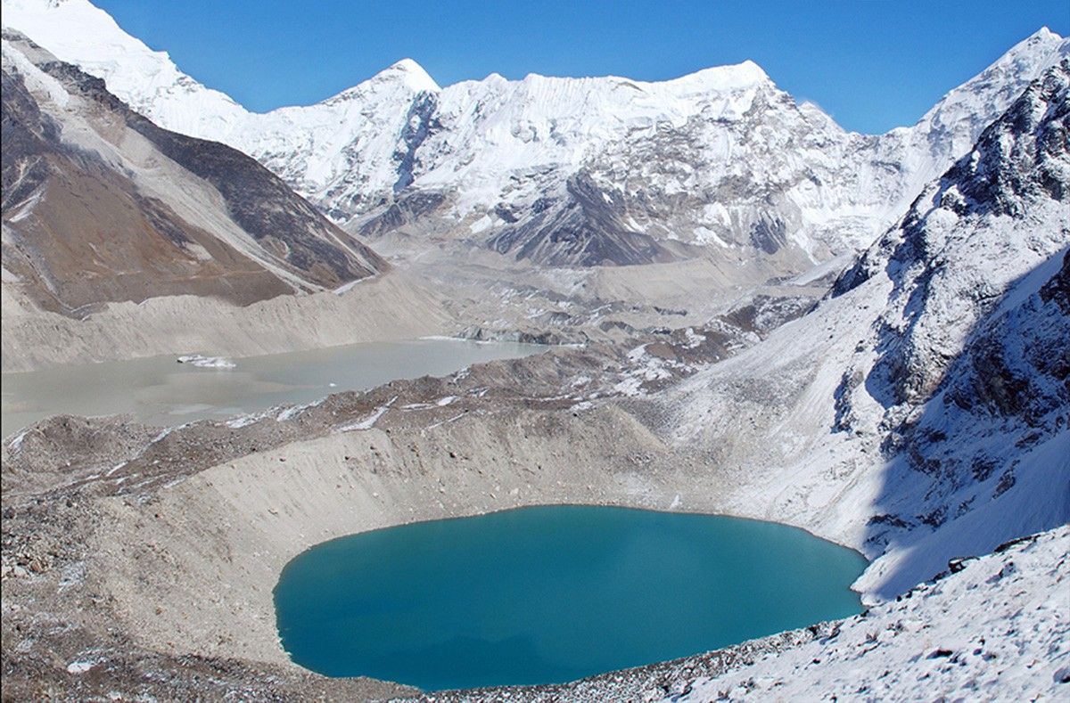 Imja Lake, the grayish glacial lake seen above Amphu Lake in the 2007 image, threatens to flood downstream communities if its unstable natural dam—consisting of dirt and rocks cemented by ice—gives way. It survived the Nepal earthquake of 2015 but remains hazardous. Imja Lake coalesced from a series of melt ponds that began forming on Imja Glacier, near Mt. Everest in the Himalayas, around 1960. By the mid-1970s, the ponds had merged into a single body of water, which has grown as the glaciers feeding it have retreated and thinned. The United Nations Development Programme has embarked on a project to lower the lake level and reduce the flood potential. Images: 1956 picture courtesy of the Association for Comparative Alpine Research, Munich; photo taken by Erwin Schneider. 2007 picture courtesy of the Archives of Alton Byers and the Mountain Institute; photo taken by Alton Byers. Sources for text: “Nepal's Imja Lake, Khumbu Region, Appears Resilient Against Gorkha Quake” and United Nations Development Programme.