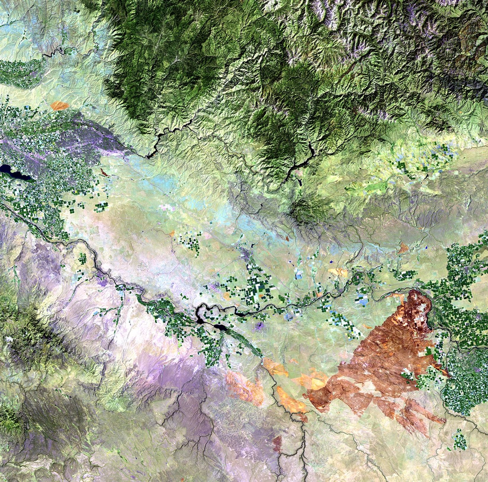 Left: July 24, 2010. Right: August 25, 2010. A series of wildfires, triggered by lightning strikes during the weekend of August 21 and 22, 2010, burned more than 300,000 acres of sage and grasses in the south-central region of Idaho. On August 23, the fire burned over 200,000 acres in a single day. Smoke from the fires dramatically impacted air quality in a number of local communities. The July 24 image shows burn marks from earlier, smaller fires, while the August 25 image shows the dark brown tone of the large fire scar. Fire and regional vegetation-management teams used the imagery to track the fire and to plan rehabilitation of the affected areas.   Images taken by the Thematic Mapper sensor onboard Landsat 5. Source: USGS Landsat Missions Gallery, 