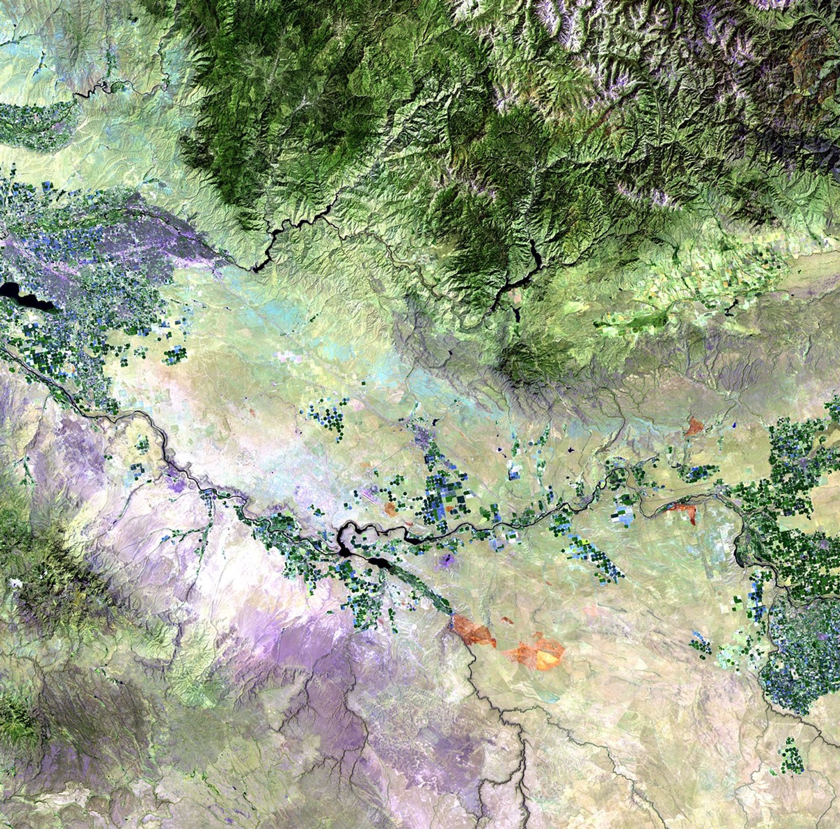 Left: July 24, 2010. Right: August 25, 2010. A series of wildfires, triggered by lightning strikes during the weekend of August 21 and 22, 2010, burned more than 300,000 acres of sage and grasses in the south-central region of Idaho. On August 23, the fire burned over 200,000 acres in a single day. Smoke from the fires dramatically impacted air quality in a number of local communities. The July 24 image shows burn marks from earlier, smaller fires, while the August 25 image shows the dark brown tone of the large fire scar. Fire and regional vegetation-management teams used the imagery to track the fire and to plan rehabilitation of the affected areas.   Images taken by the Thematic Mapper sensor onboard Landsat 5. Source: USGS Landsat Missions Gallery, 
