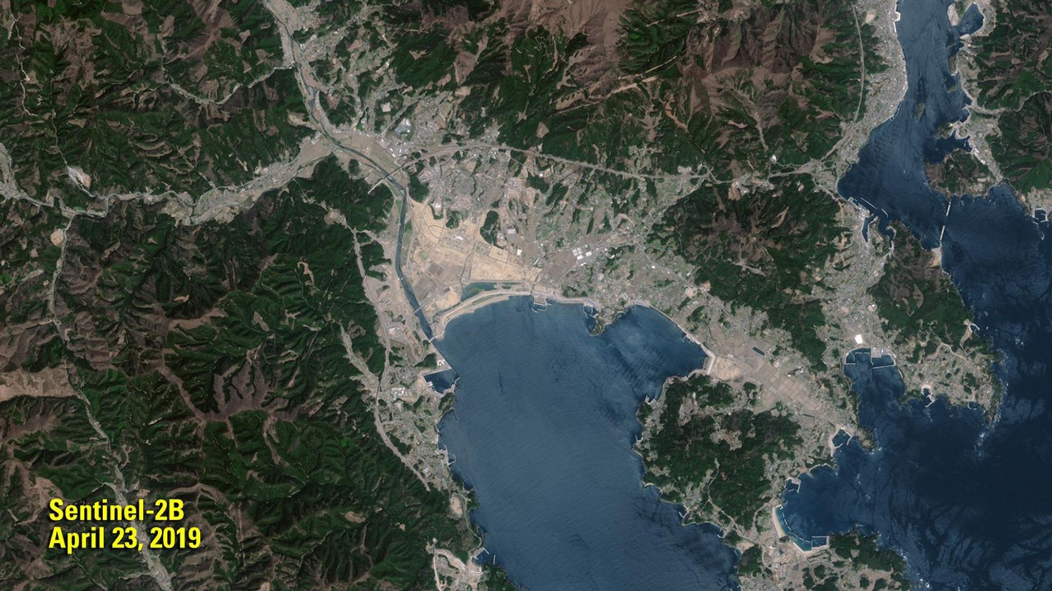 The 2011 image shows the remains of the Japanese town of Rikuzentakata (gray area in center) less than a month after a devastating tsunami. In the 2019 image, a sea wall, 41 feet (12.5 meters) high, stands between the town and Hirota Bay as a shield against future tsunamis. The 2011 image was taken by Landsat 5. The 2019 image was taken by ESA's Sentinel-2B satellite. Source: U.S. Geological Survey’s National Land Imaging Image Collections