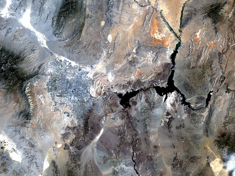 Lake Mead is one of the largest reservoirs in the world, supplying water to California, Arizona, Nevada and Mexico, including the water-guzzling Las Vegas. Through dam turbines, the lake also provides power to Nevada, southern California and northern Mexico. Since 2000, the water level has been dropping at a fairly steady rate due to lower-than-average snowfall and over a decade of drought, and as of July 2010, the lake was at 38 percent of its capacity. Water supply has been further diminished by the drawing off of water from upstream reservoirs in the upper Colorado River Basin which, historically, has been the source for the Lake Mead Reservoir. Also see this image pair of Lake Mead.   Images taken by the Thematic Mapper sensor onboard Landsat 5. Source: U.S. Geological Survey (USGS) Landsat Missions Gallery, "Lake Mead, Nevada," U.S. Department of the Interior / USGS.