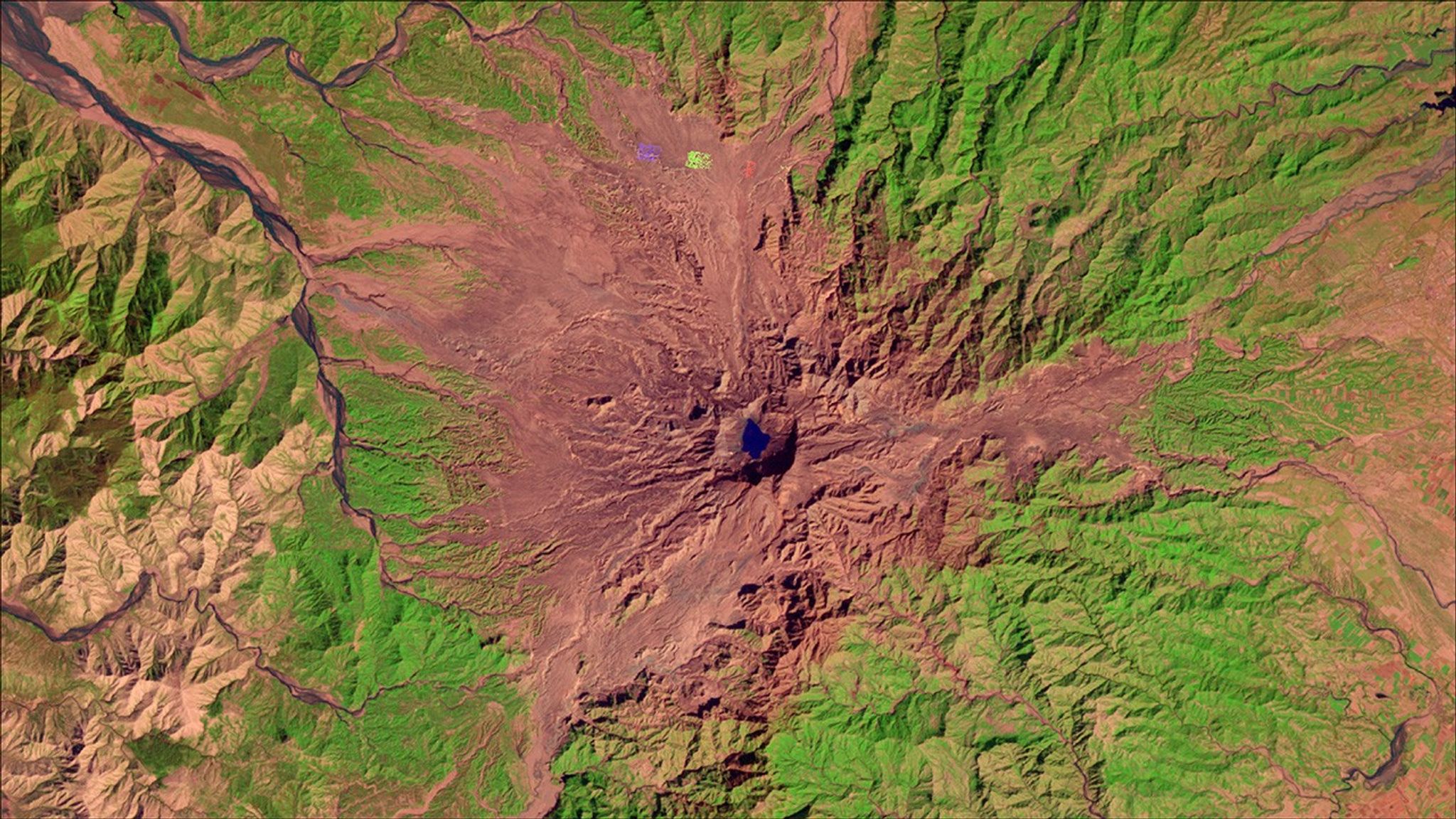 Mount Pinatubo had likely been dormant for hundreds of years, making it difficult to persuade local residents to evacuate once it began showing signs of an eruption during the spring of 1991. When it did erupt on June 15, 1991, it was one of the largest volcanic eruptions of the 20th century. Today, the mountain is relatively quiet and about 984 feet (about 300 meters) shorter than it was before the eruption. In the 2017 image (right), green near the summit indicates forest regrowth, and pink stretches streaming from the mountain show scars from fast-moving floods of volcanic ash and water. Called “lahars,” these floods affected more people than the eruption itself and continue to be hazardous. Images taken by Landsat. Source: U.S. Geological Survey (USGS) Landsat Missions Gallery: “Mount Pinatubo, Philippines, Erupted 26 Years Ago”; U.S. Department of the Interior / USGS and NASA.
