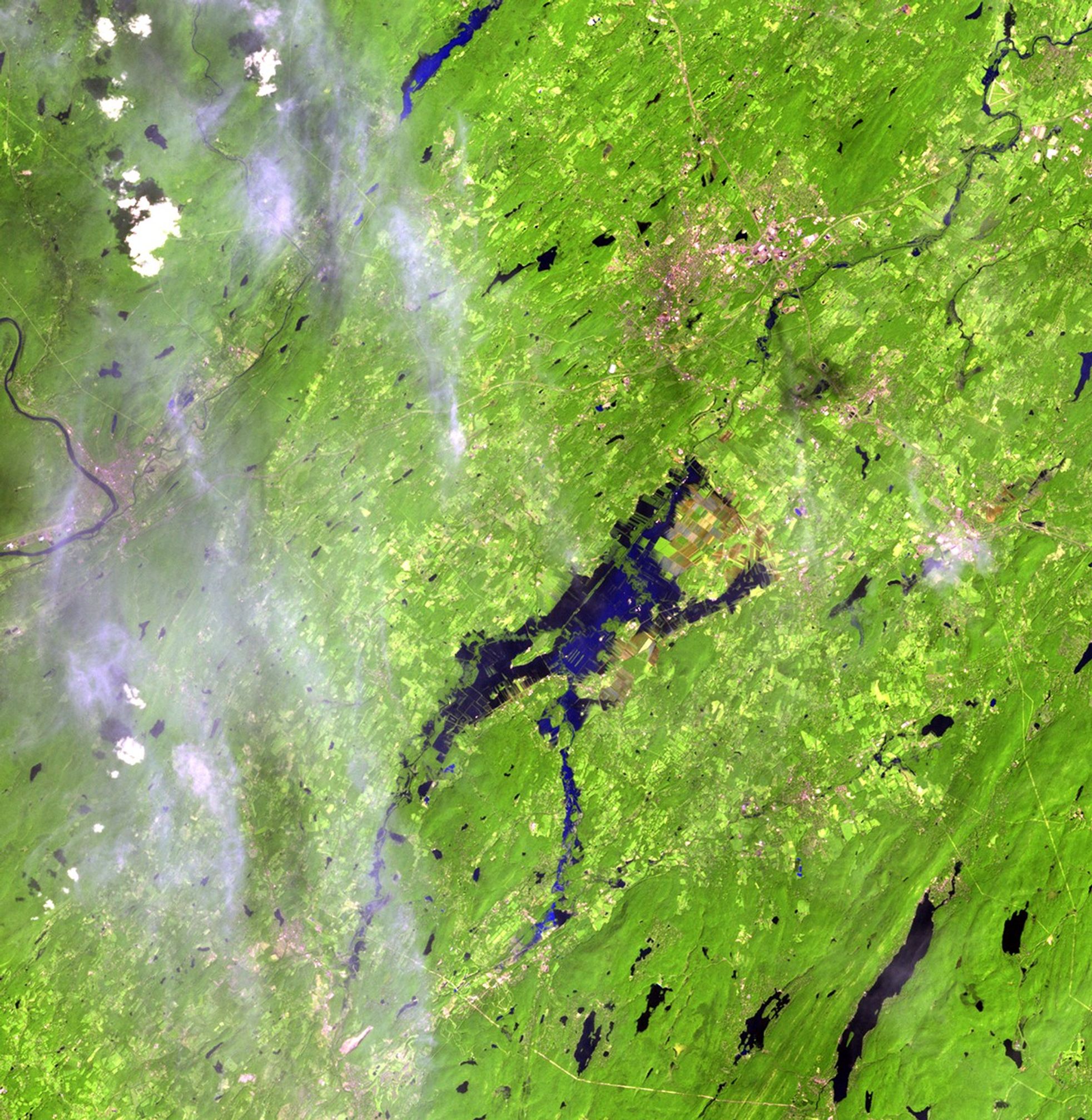 Farmland in the Black Dirt region, New York. Flooding from Hurricane Irene, shown on the right, brought an early end to the region's vegetable harvest. Located about an hour's drive from New York City, farms in the area have provided onions and other vegetables for over a century. The area used to be the bottom of a shallow lake, resulting in rich organic soil, which can be seen as deep browns and reds in the images. Images taken by the Thematic Mapper sensor aboard Landsat 5. Source: USGS Landsat Missions Gallery, "Rural New York Flooding from Hurricane Irene," U.S. Department of the Interior / U.S. Geological Survey.
