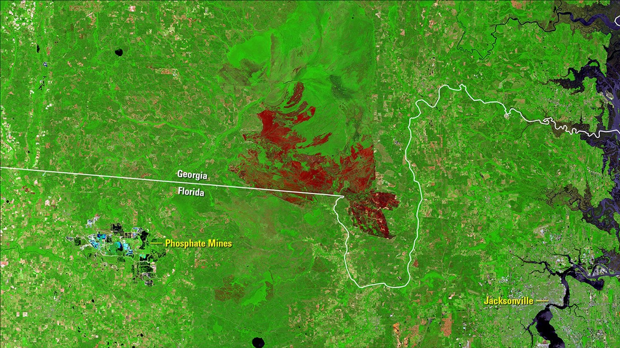 A lightning-ignited wildfire that started in the Okefenokee National Wildlife Refuge on April 6, 2017, persisted into May. Hot, dry weather and extremely dry fuels made the fire, also called the Okefenokee Fire, difficult to contain. Thick smoke affected nearby communities, its ash reported to have reached Jacksonville, Florida, about 30 miles southeast. Images taken by the Landsat 8 satellite. Source: U.S. Geological Survey (USGS) Landsat Missions Gallery: “Okefenokee Fire Continues to Burn”; U.S. Department of the Interior / USGS and NASA.