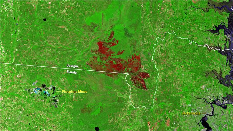 A lightning-ignited wildfire that started in the Okefenokee National Wildlife Refuge on April 6, 2017, persisted into May. Hot, dry weather and extremely dry fuels made the fire, also called the Okefenokee Fire, difficult to contain. Thick smoke affected nearby communities, its ash reported to have reached Jacksonville, Florida, about 30 miles southeast. Images taken by the Landsat 8 satellite. Source: U.S. Geological Survey (USGS) Landsat Missions Gallery: “Okefenokee Fire Continues to Burn”; U.S. Department of the Interior / USGS and NASA.