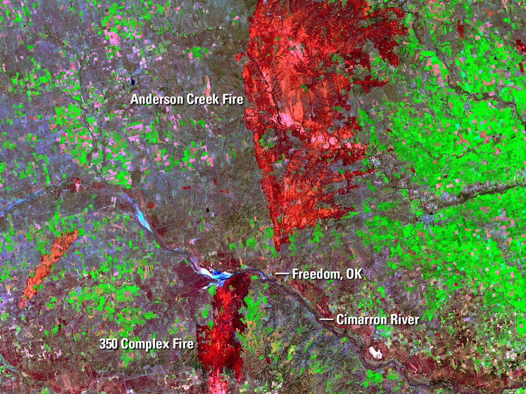 On April 5, 2016, four fires sparked by downed power lines merged and burned almost 57,500 acres near Freedom, OK, in three days. In late March, the Anderson Creek Fire started in Oklahoma and spread into Kansas, burning almost 400,000 acres and becoming the largest blaze ever in the latter state. The red areas in the April image are burn scars from the fires. In both images, a minor scar from an earlier fire appears orange. As of April 8, the National Interagency Fire Center in Boise, Idaho, reported that 817,480 acres had burned year-to-date across the country, the largest tally in that time frame since 2006. Images taken by the Operational Land Imager onboard Landsat 8 and the Enhanced Thematic Mapper Plus onboard Landsat 7. Source: U.S. Geological Survey (USGS) Landsat Missions Gallery; Wildfires Scorch Large Swaths Along Oklahoma-Kansas border; U.S. Department of the Interior / USGS and NASA.