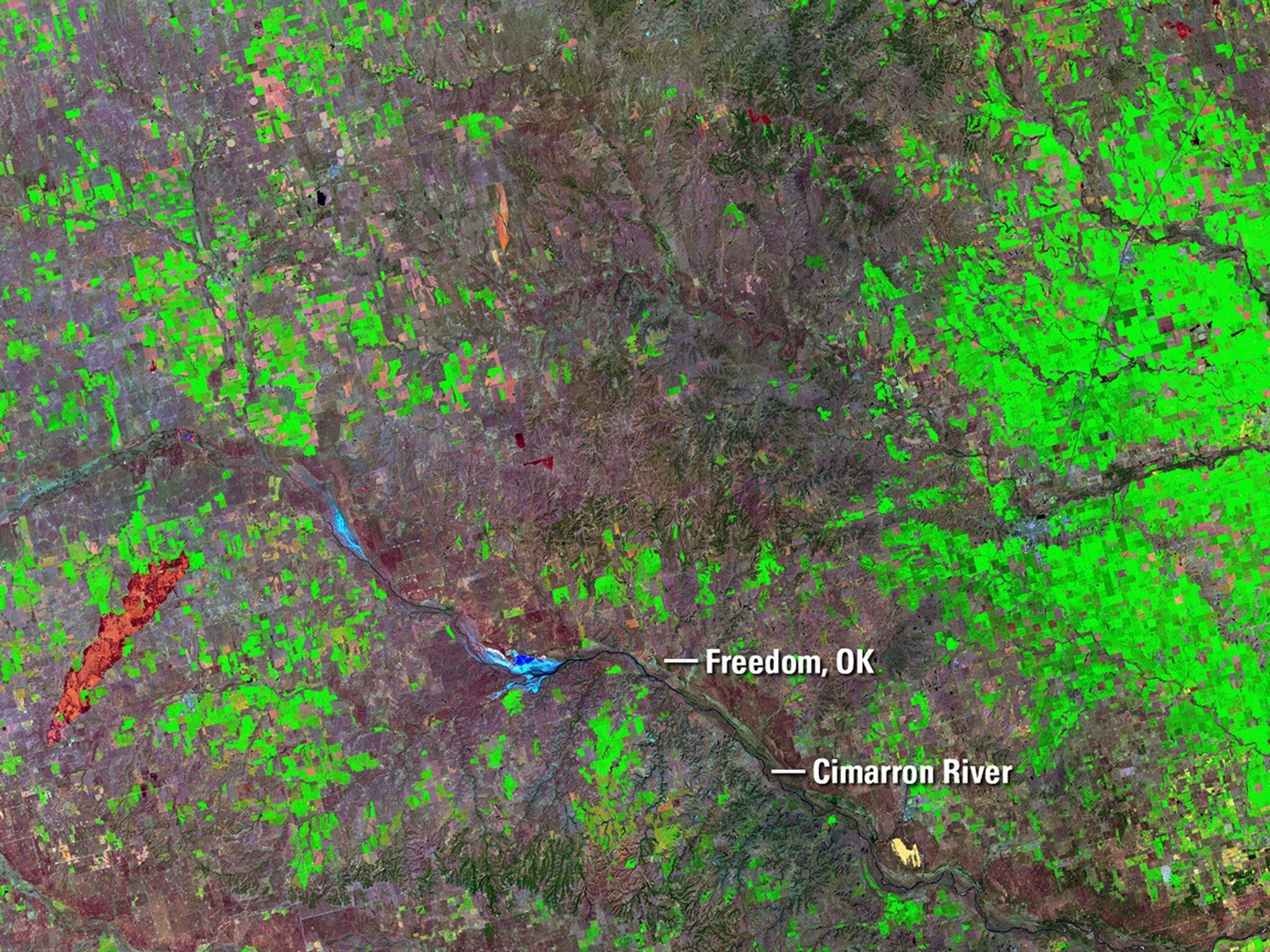 On April 5, 2016, four fires sparked by downed power lines merged and burned almost 57,500 acres near Freedom, OK, in three days. In late March, the Anderson Creek Fire started in Oklahoma and spread into Kansas, burning almost 400,000 acres and becoming the largest blaze ever in the latter state. The red areas in the April image are burn scars from the fires. In both images, a minor scar from an earlier fire appears orange. As of April 8, the National Interagency Fire Center in Boise, Idaho, reported that 817,480 acres had burned year-to-date across the country, the largest tally in that time frame since 2006.   Images taken by the Operational Land Imager onboard Landsat 8 and the Enhanced Thematic Mapper Plus onboard Landsat 7. Source: U.S. Geological Survey (USGS) Landsat Missions Gallery; Wildfires Scorch Large Swaths Along Oklahoma-Kansas border; U.S. Department of the Interior / USGS and NASA.