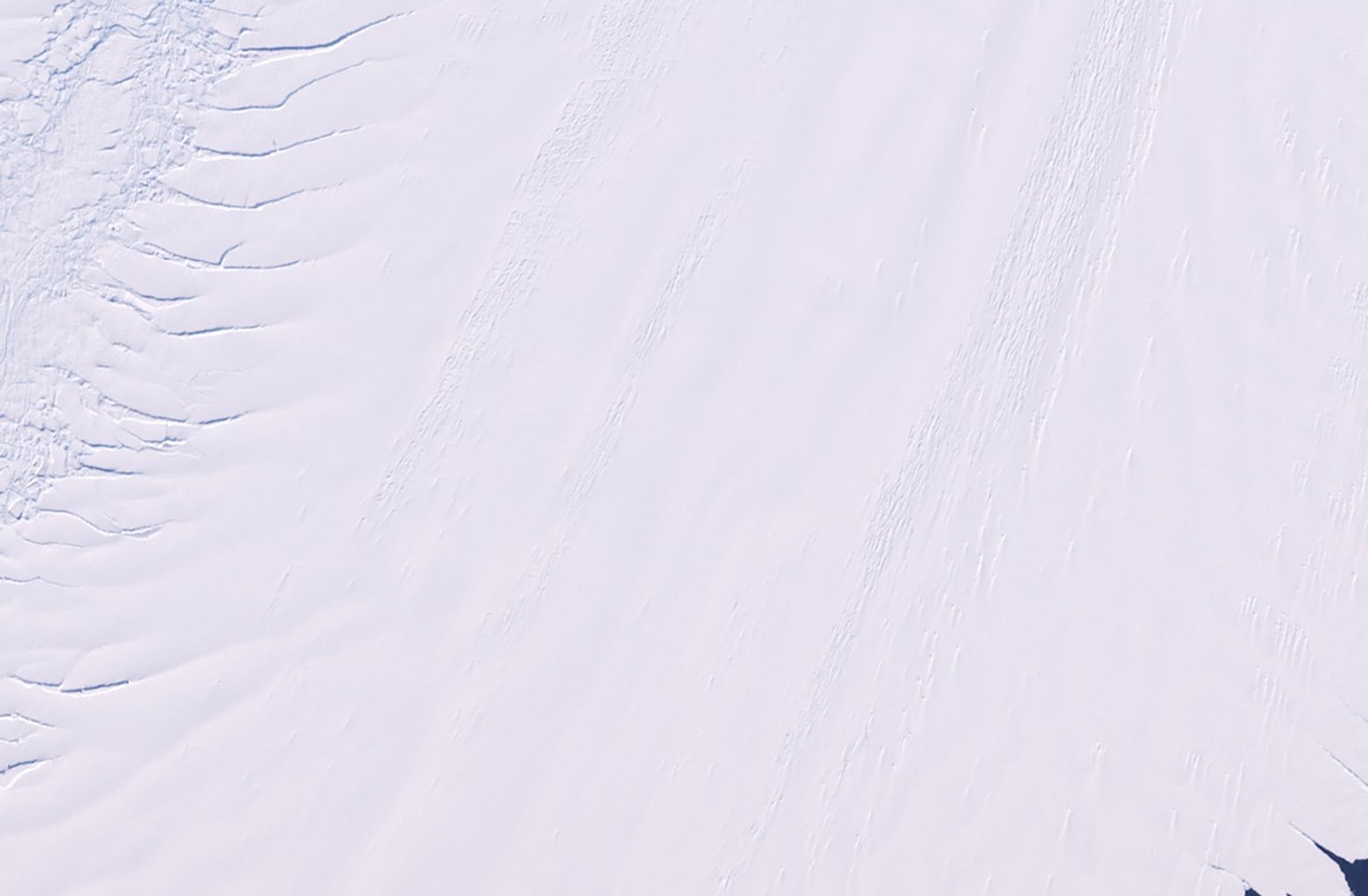 Pine Island is one of the largest and fastest-moving glaciers in Antarctica. The Pine Island Glacier Basin contributes more ice to the sea than any other ice-drainage basin in the world, and this has increased due to recent acceleration of the ice stream caused by thinning of the glacier. Scientists are concerned about the impact Pine Island's continued thinning will have on sea level. The 2011 image shows a series of splits along the western edge of the glacier. The same area in 2012 reveals a major break that will eventually extend all the way across the glacier and calve a giant iceberg expected to cover about 350 square miles (900 square kilometers). Images taken by the Enhanced Thematic Mapper Plus sensor onboard Landsat 7. Source: U.S. Geological Survey (USGS) Landsat Missions Gallery, "Pine Island Glacier," U.S. Department of the Interior / USGS.