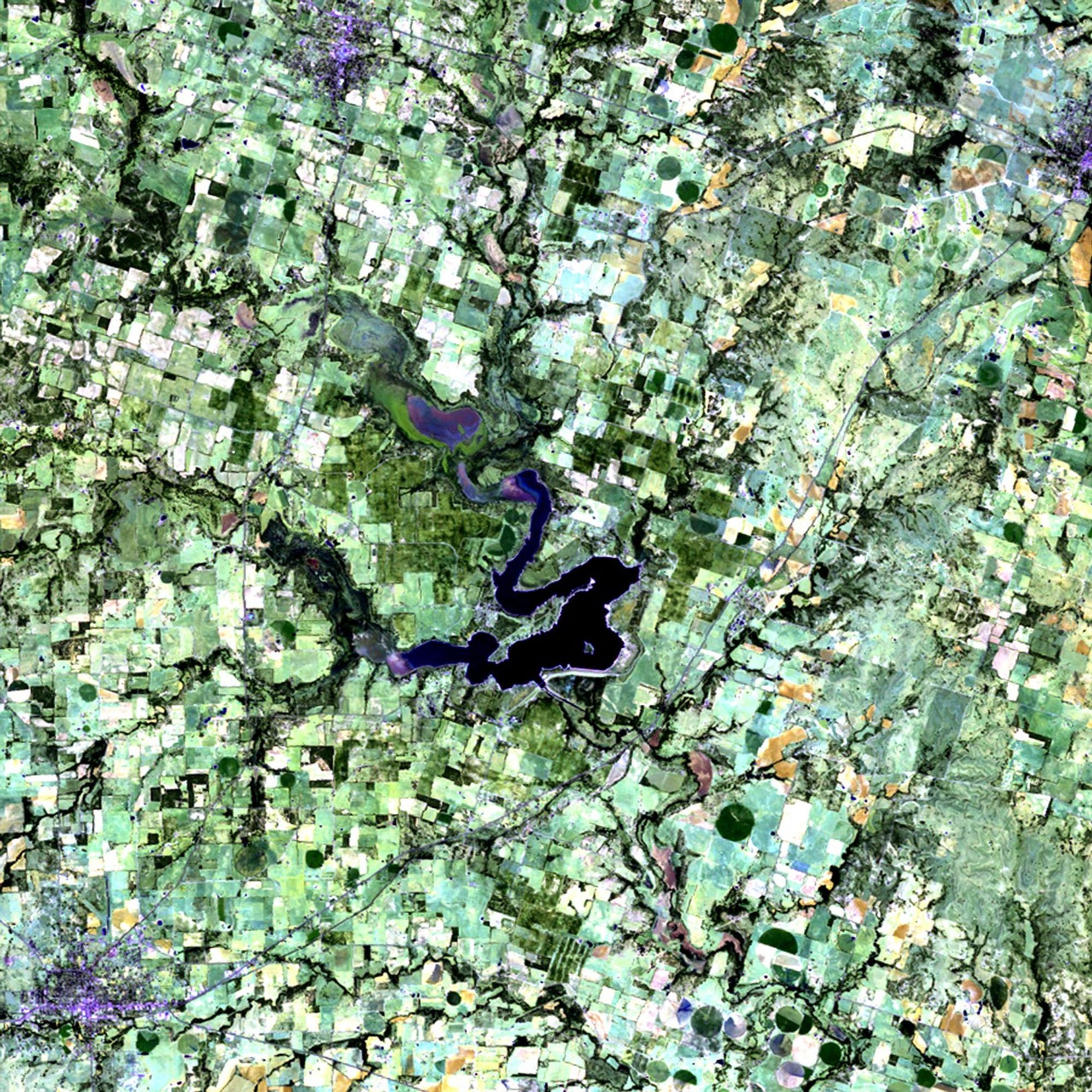 Dry conditions since mid-2010 have caused a large portion of Texas to be in an "exceptional" state of drought, the worst condition on the Federal government's drought monitor scale. The 12-month period between October 2010 and September 2011 was the driest in Texas since 1895, when the state began keeping rainfall records. Not only have crops and farmland been affected, but the levels of many lakes in the state have also fallen. Seen here is the area surrounding Proctor Lake, southwest of Dallas. Much of 2010's green vegetation has given way to barren ground (lighter shades) in 2011. Reduced water levels from the two major feeder rivers, the Sabanna and Leon Rivers, are responsible for the lake's receding shoreline. Proctor Lake reservoir was created by the U.S. Army Corps of Engineers in 1963 as a flood-control measure, and provides drinking water and recreation facilities to neighboring communities. Images taken by the Thematic Mapper sensor onboard Landsat 5. Source: USGS Landsat Missions Gallery, "Proctor Lake Affected by Texas Drought," U.S. Department of the Interior / U.S. Geological Survey.