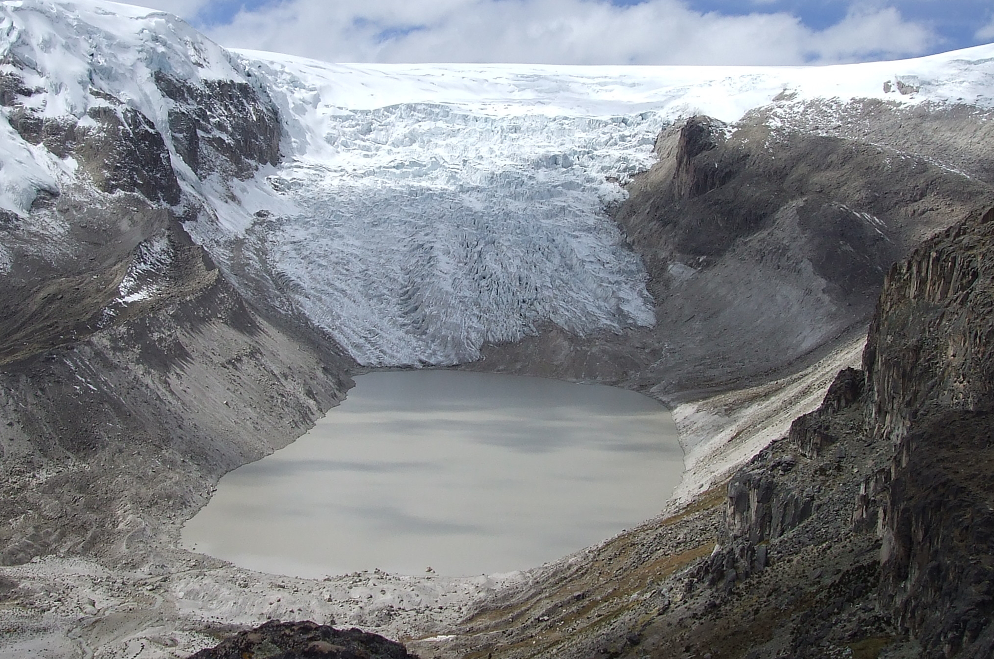 Qori Kalis is the largest outlet glacier of the world’s largest tropical ice cap, the Quelccaya Ice Cap, which lies on a plateau 18,670 feet (5,691 meters) high in the Andes mountains of south central Peru. In 1978, the glacier was still advancing. By 2011, the glacier had retreated completely back on the land, leaving a lake some 86 acres in area and about 200 feet (60 meters) deep.   Source: Dr. Lonnie G. Thompson, Distinguished University Professor, Byrd Polar and Climate Research Center, The Ohio State University