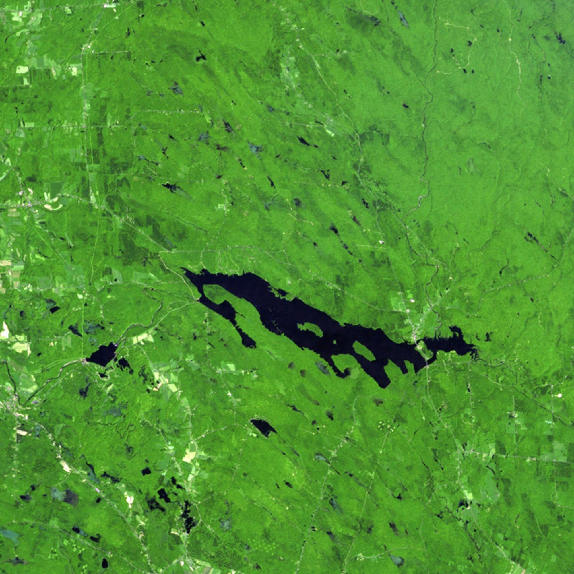 The Salmon River Reservoir in New York State was created in 1914, when a hydroelectric power dam was built. Water levels fluctuate with spring showers and winter snowmelt, but the reservoir has steadily grown since the Landsat satellite began monitoring it in 1985. Record rainfall in September 2010 was a major cause of the reservoir's expansion seen in the 2011 picture. When lowlands flooded after the rain, the reservoir proved critical in holding back waters that would have caused extensive damage to shoreline property downstream. Land managers and other officials use Landsat images to help them make decisions about additional growth or diversion of water in this area.   Images taken by the Thematic Mapper sensor onboard Landsat 5. Source: U.S. Geological Survey (USGS) Landsat Missions Gallery, "Salmon River Reservoir, New York 1985-2011," U.S. Department of the Interior / USGS and N