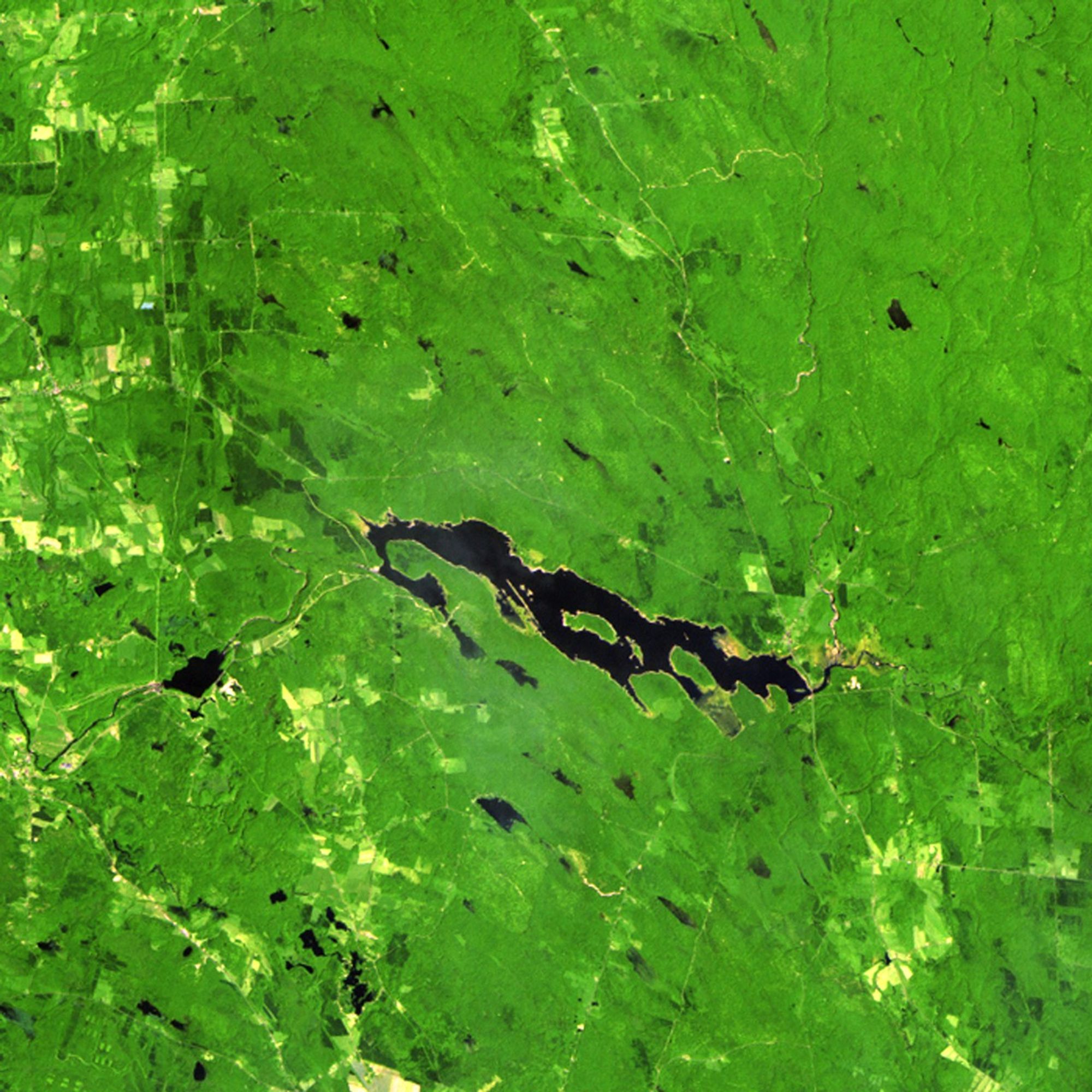 The Salmon River Reservoir in New York State was created in 1914, when a hydroelectric power dam was built. Water levels fluctuate with spring showers and winter snowmelt, but the reservoir has steadily grown since the Landsat satellite began monitoring it in 1985. Record rainfall in September 2010 was a major cause of the reservoir's expansion seen in the 2011 picture. When lowlands flooded after the rain, the reservoir proved critical in holding back waters that would have caused extensive damage to shoreline property downstream. Land managers and other officials use Landsat images to help them make decisions about additional growth or diversion of water in this area.   Images taken by the Thematic Mapper sensor onboard Landsat 5. Source: U.S. Geological Survey (USGS) Landsat Missions Gallery, "Salmon River Reservoir, New York 1985-2011," U.S. Department of the Interior / USGS and N