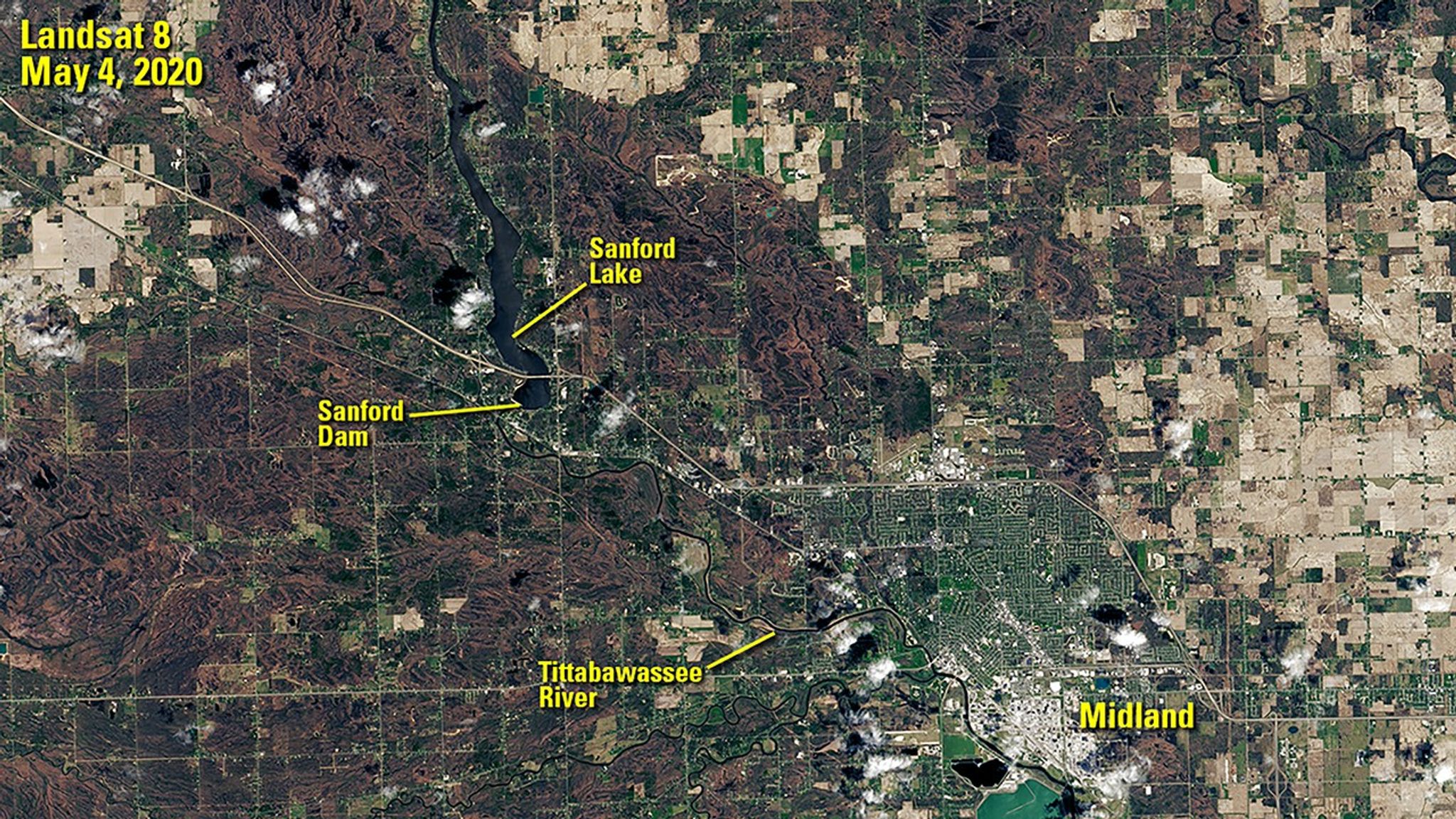 Sanford Dam failed on May 19, 2020, flooding the area downstream. The image on the right was taken the following day, when the Tittabawassee River peaked some 10 feet above flood stage at Midland, Michigan. Muddy floodwater is visible spilling onto land near the river. The image on the left shows the region before the flooding, when the dam still held back the waters of Sanford Lake. Images taken by the Landsat 8 satellite. Source: U.S. Geological Survey’s Earth Resources Observation and Science Center