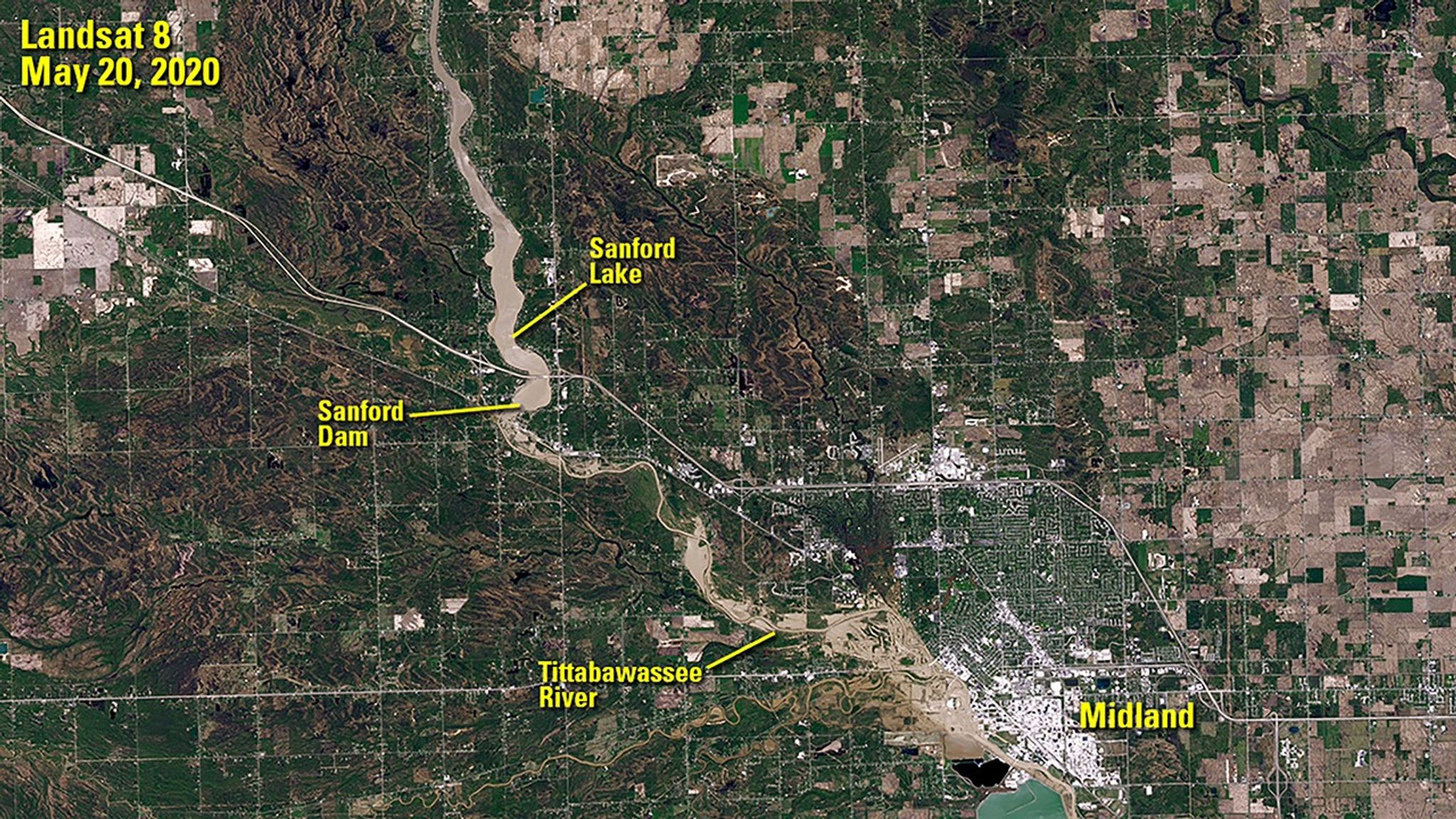 Sanford Dam failed on May 19, 2020, flooding the area downstream. The image on the right was taken the following day, when the Tittabawassee River peaked some 10 feet above flood stage at Midland, Michigan. Muddy floodwater is visible spilling onto land near the river. The image on the left shows the region before the flooding, when the dam still held back the waters of Sanford Lake. Images taken by the Landsat 8 satellite. Source: U.S. Geological Survey’s Earth Resources Observation and Science Center