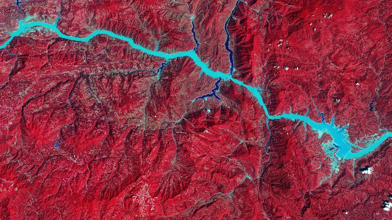 China’s Three Gorges Dam on the Yangtze River became the world’s largest hydroelectric power plant upon its completion in 2012. It has also eased flooding and river navigation and provided water for irrigation. However, construction forced some 1.2 million people to relocate and, according to a 2010 study, triggered about 3,400 earthquakes and numerous landslides from mid-2003 through 2009. Changes in river flow have raised concerns about silt accumulation and biodiversity loss. Important archeological sites and ancient monuments were reportedly inundated as the reservoir filled. Forested areas appear red in these images to represent measurements by infrared sensors. 1993 image: Landsat 5. 2016 image: Landsat 8. Source: U.S. Geological Survey (USGS) Landsat Missions Gallery; U.S. Department of the Interior / USGS and NASA.
