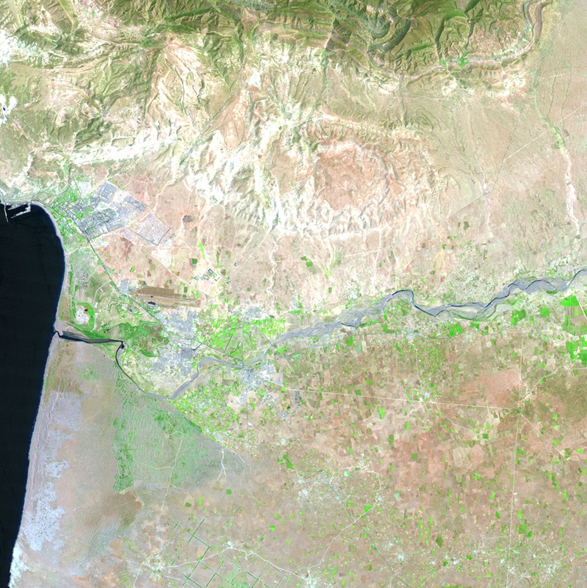 The Moroccan cities of Agadir, Inezgane and Tikiouine are close to the Atlantic coastline (seen in blue in the images), and stretch into the foothills of the Atlas Mountains. Agadir was nearly destroyed by an earthquake in 1960. Reconstruction has focused on tourism, turning this area into a winter destination. The 1985 image shows the area 25 years into the rebuilding. By 2011, the urban areas reach into the Sahara Desert. Growth has been influenced by the expanding fishing industry and modern commercial ports. Images taken by the Thematic Mapper sensor onboard Landsat 5. Source: USGS Landsat Missions Gallery, "Urban Growth in Morocco, 1985-2011," U.S. Department of the Interior / U.S. Geological Survey.