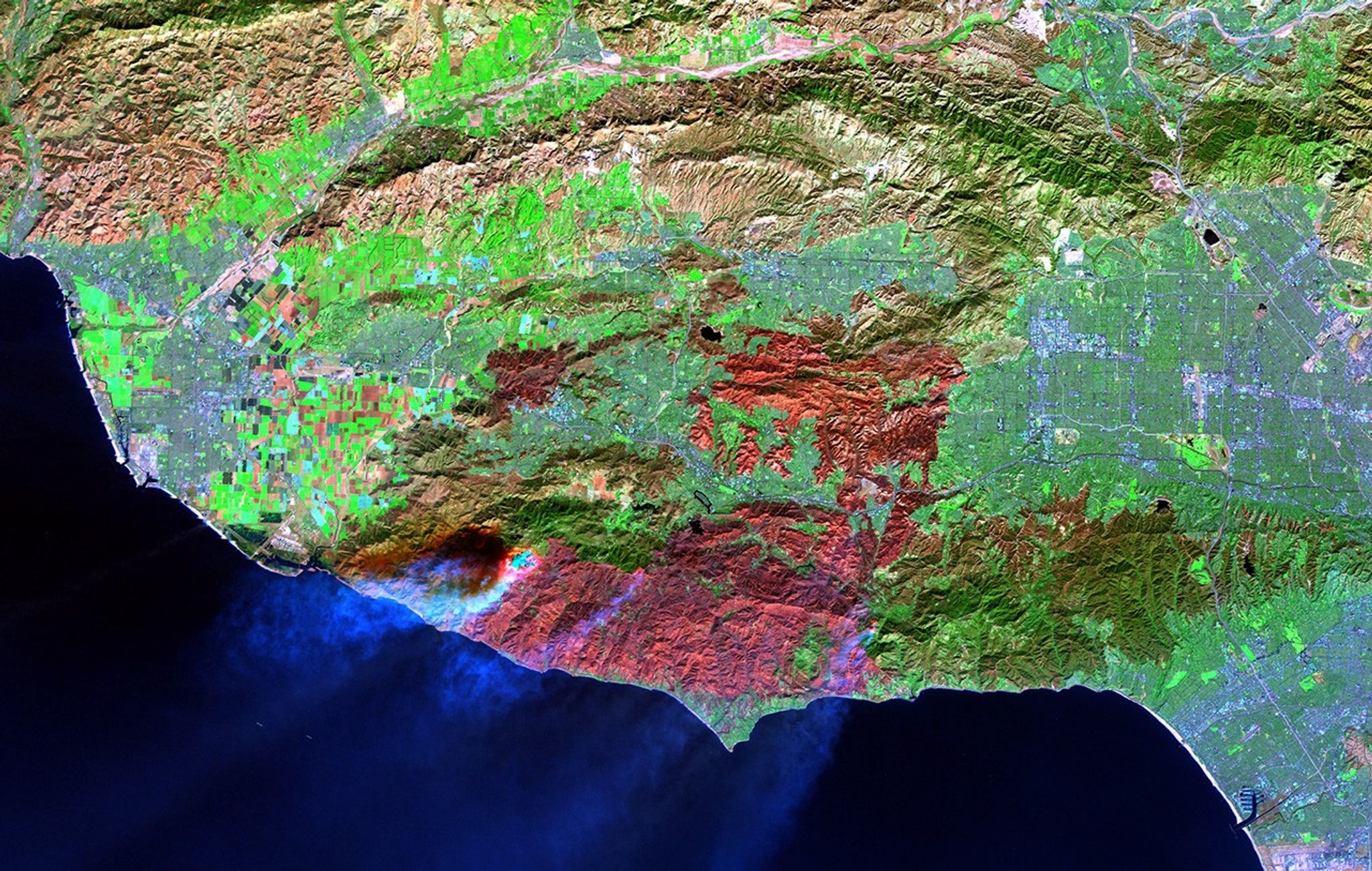 The Woolsey Fire burned some 97,000 acres of Southern California in November 2018. The large maroon patch at the bottom of the later image shows, in false color, the burn scar between Los Angeles, Thousand Oaks and Malibu. The earlier image shows the same region before the fire began. See also the Camp, Mendocino Complex, County, Thomas, and Wine Country fires.   Earlier image taken by Landsat 8, later image taken by Landsat 7. Source: U.S. Geological Survey’s Earth Resources and Science Center