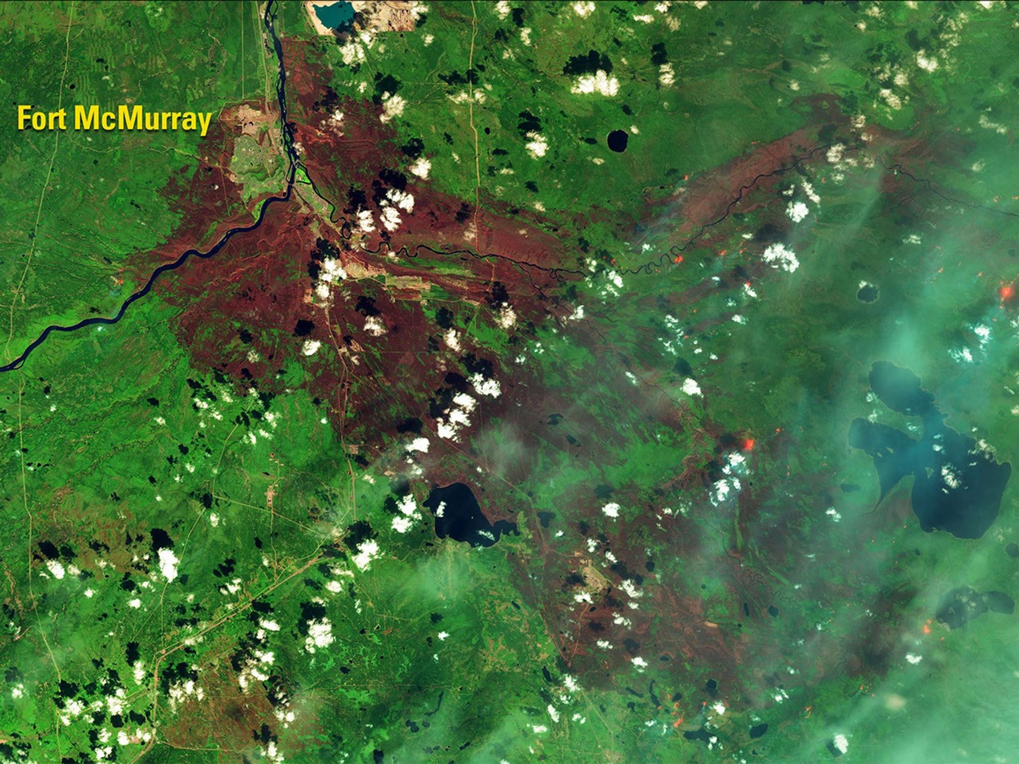 The Fort McMurray wildfire, one of the most destructive in Canada’s history, has burned some 600,000 acres, including nearly 10 percent of the city. In the 2016 false-color image, blue haze indicates smoke, bright orange shows active fires and the reddish-brown areas are burn scars. Fire destroyed more than 2,400 structures and damaged at least 500 more. See also this account. Images taken by the Operational Land Imager onboard Landsat 8. Source: U.S. Geological Survey (USGS) Landsat Missions Gallery; “Landsat 8 Shows Burn Extent, Active Fire at Fort McMurray;” U.S. Department of the Interior / USGS and NASA.
