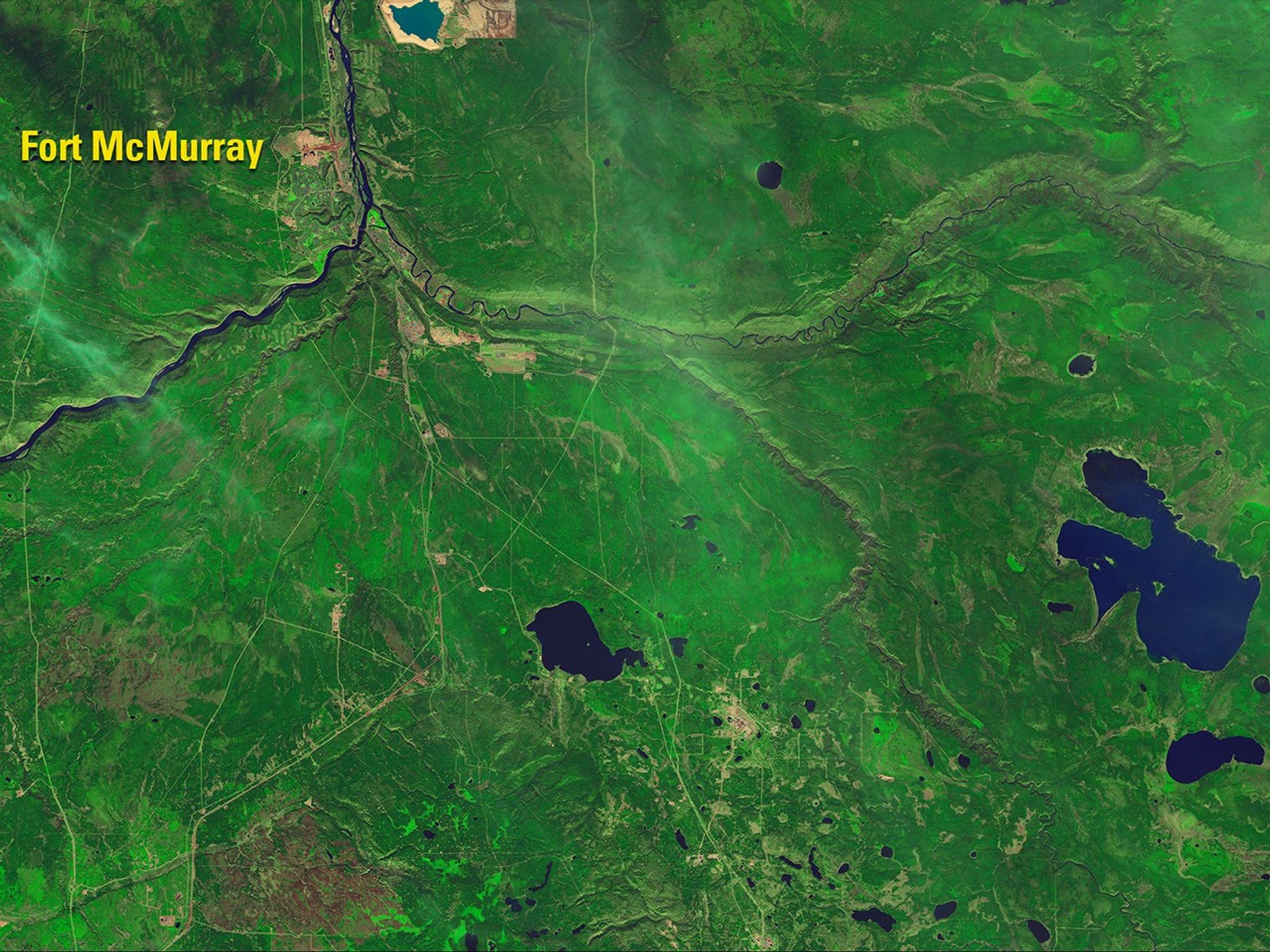The Fort McMurray wildfire, one of the most destructive in Canada’s history, has burned some 600,000 acres, including nearly 10 percent of the city. In the 2016 false-color image, blue haze indicates smoke, bright orange shows active fires and the reddish-brown areas are burn scars. Fire destroyed more than 2,400 structures and damaged at least 500 more. See also this account. Images taken by the Operational Land Imager onboard Landsat 8. Source: U.S. Geological Survey (USGS) Landsat Missions Gallery; “Landsat 8 Shows Burn Extent, Active Fire at Fort McMurray;” U.S. Department of the Interior / USGS and NASA.