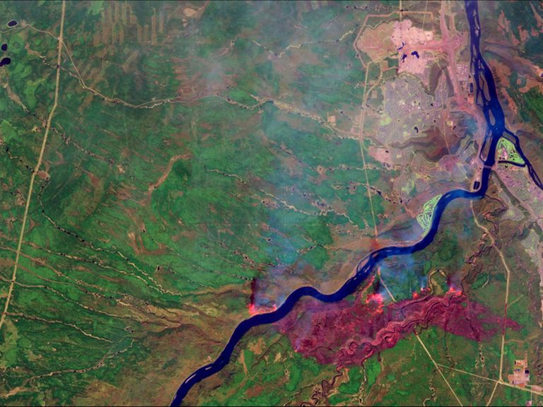 A massive wildfire near Fort McMurray in Alberta, Canada, destroyed at least 1,600 structures and forced the largest evacuation on record in Canada, involving more than 88,000 people. By May 5, fire had consumed almost 210,000 acres. The false-color images in the May picture depict active hot spots as bright orange, the burned area as dark red and smoke as hazy blue. This location is home to the Athabasca oil sands, the largest known reservoir of crude bitumen in the world. Images taken by the Operational Land Imager onboard Landsat 8. Source: U.S. Geological Survey (USGS) Landsat Missions Gallery; Wildfire Forces Evacuations in Fort McMurray, Alberta; U.S. Department of the Interior / USGS and NASA.