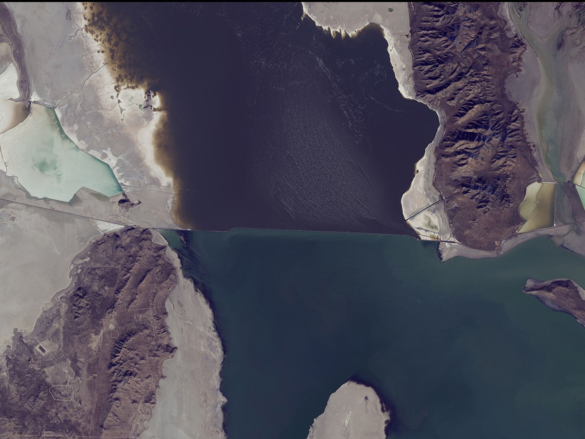 The water level of the north arm of Great Salt Lake, Utah, has reached a record low of 4,191.6 feet because the smaller snowpack of recent years has reduced the spring runoff that feeds the lake. The south arm’s water has dropped below the level where it could cross the breach that separates the arms. Water from the north arm is pumped to evaporation ponds, seen on the right side of these images, from which salt, potassium and other minerals are extracted. Also see this USGS article. Images taken by the Thematic Mapper sensor onboard Landsat 5 and the Operational Land Imager onboard Landsat 8. Source: Landsat Missions Gallery “Great Salt Lake North Arm Reaches Record Low.” U.S. Department of the Interior / USGS and NASA; and USGS Newsroom.