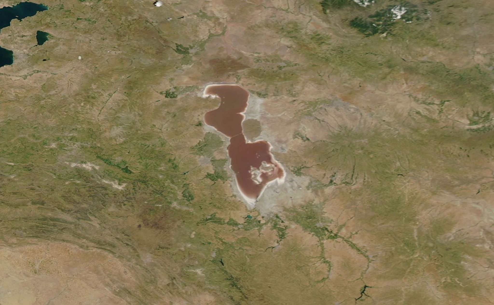 Iran's Lake Urmia is one of the world's largest hypersaline (extremely salty) lakes. It has been declared a Wetland of International Importance and a UNESCO Biosphere Reserve. But as reported by the United Nations Environment Programme, its water level began to decline rapidly in the mid-1990s. Incoming water was diverted for agricultural use, dams blocked inflowing rivers, rainfall decreased, and rising temperatures brought increased evaporation. Torrential rains in 2018 and 2019 helped to replenish the lake, as seen in the June image, which shows Urmia largely filled with water tinted red by bacteria or algae. But by the time of the November image, the lake was once again drying out. Read more at NASA's Earth Observatory. Images taken by the Moderate Resolution Imaging Spectroradiometer (MODIS) instrument on NASA's Aqua satellite. Source: NASA's Earth Observatory Download images:image 1image 2
